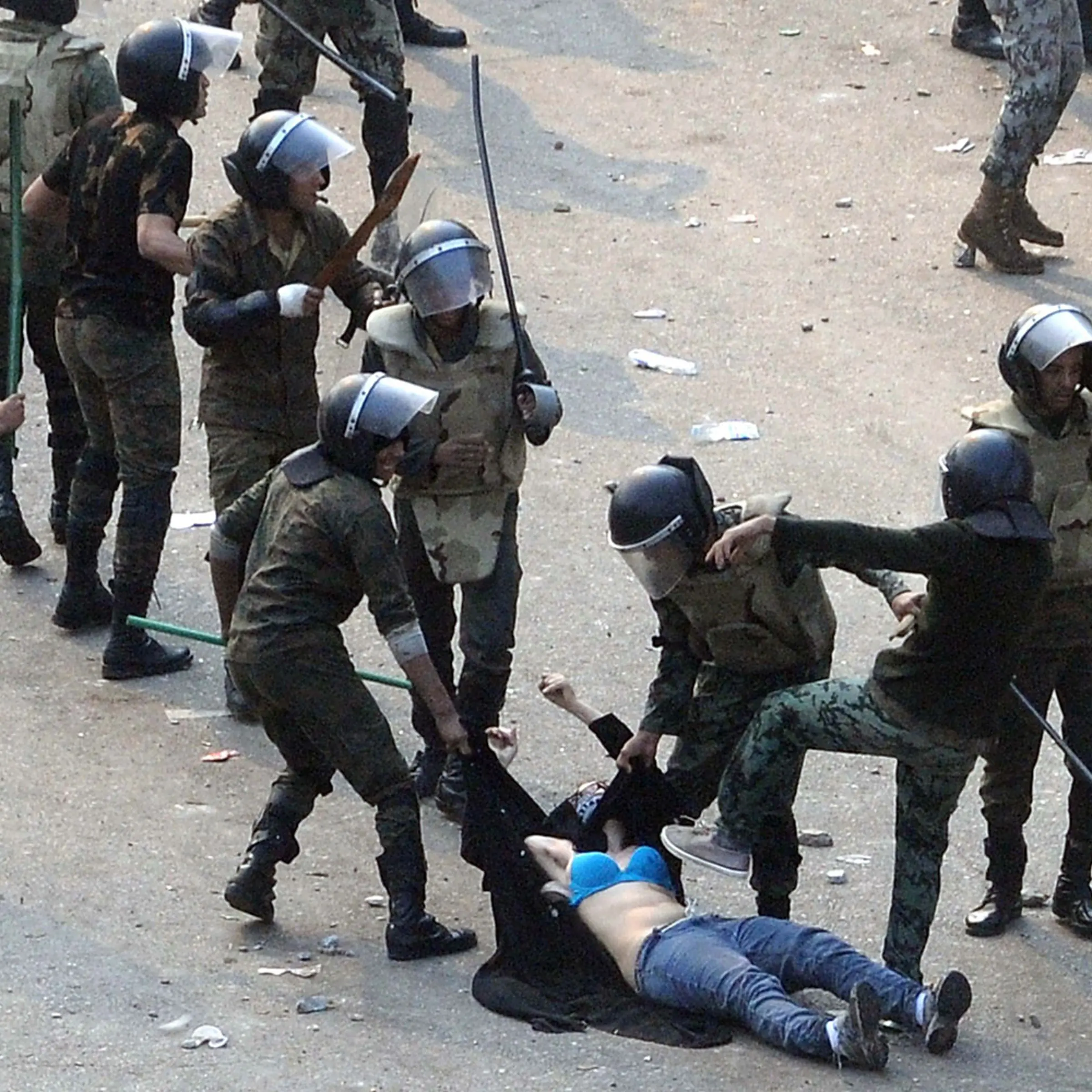 December 17, 2011. Egyptian army soldiers arrest a female protester during clashes at Tahrir Square in Cairo. Soldiers beat demonstrators with batons in Cairo's Tahrir Square on Saturday in a second day of clashes that have killed nine people and wounded more than 300, marring the first free election most Egyptians can remember.
