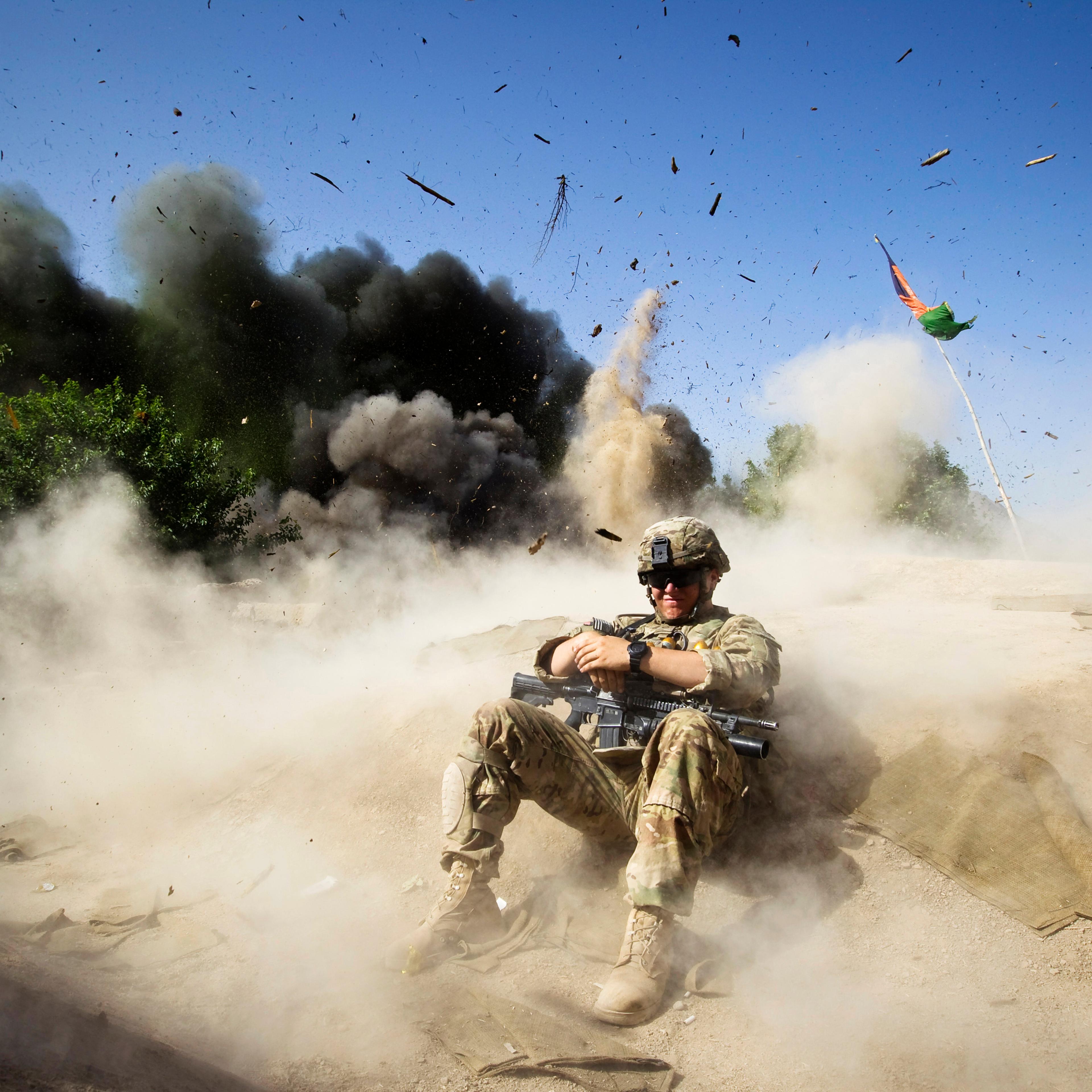 Jake Beaudoin, a U.S. Army Private of 82nd Airborne Division, takes cover during a controlled detonation to clear an area for setting up a check point in Zahri district of Kandahar province