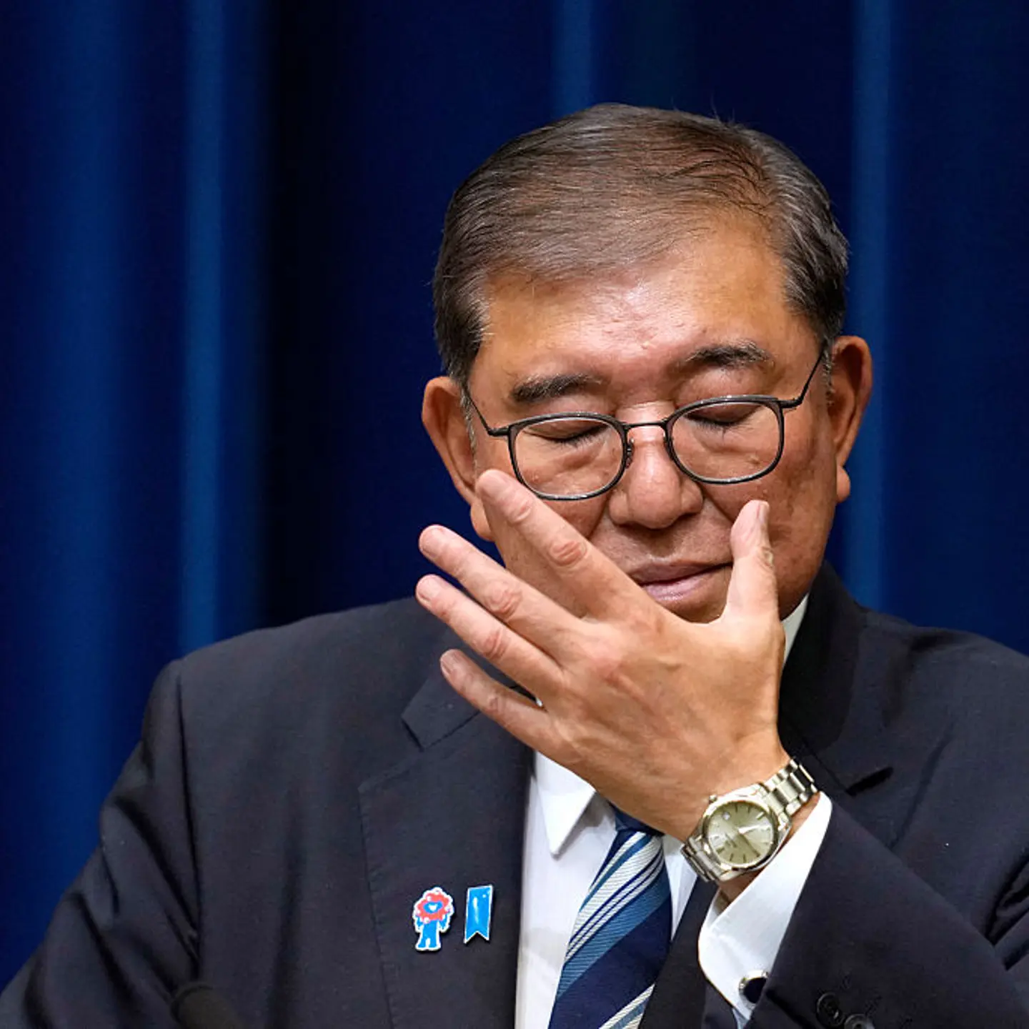 Japan's Prime Minister Shigeru Ishiba adjusts his glasses during a press conference at the prime minister's office in Tokyo on Sept. 7, 2025.