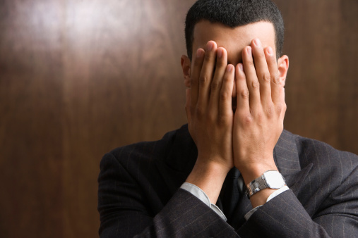 businessman-hands-over-face
