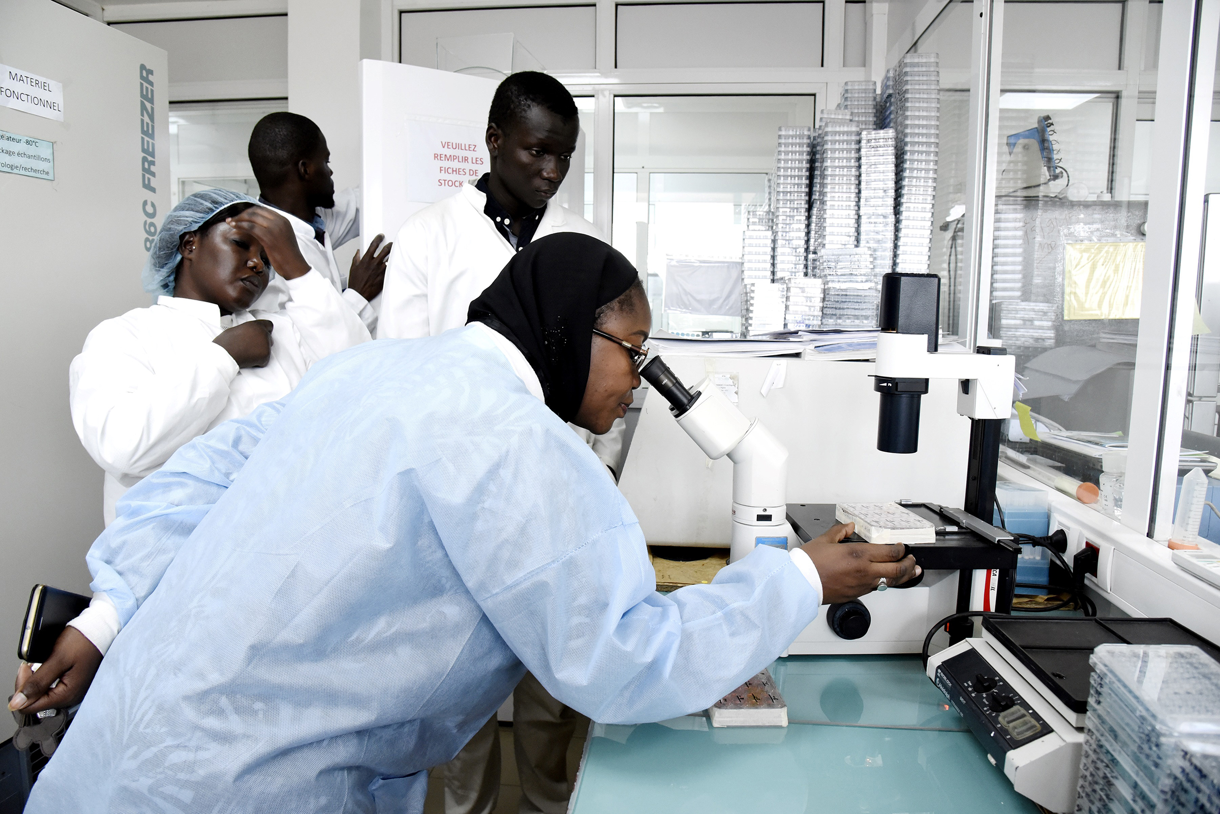 Scientific staff members work in a secure laboratory, researching the coronavirus, at the Pasteur Institute in Dakar, Senegal, on Feb. 3, 2020.
