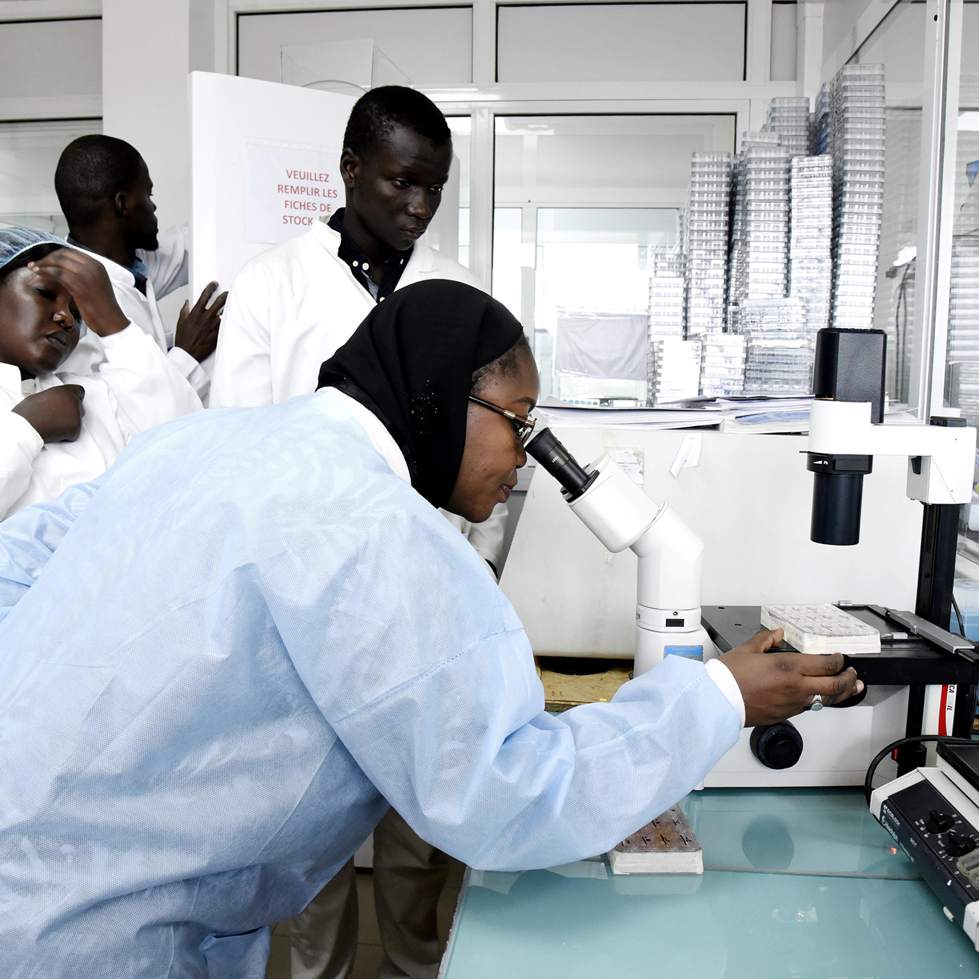 Scientific staff members work in a secure laboratory, researching the coronavirus, at the Pasteur Institute in Dakar, Senegal, on Feb. 3, 2020.