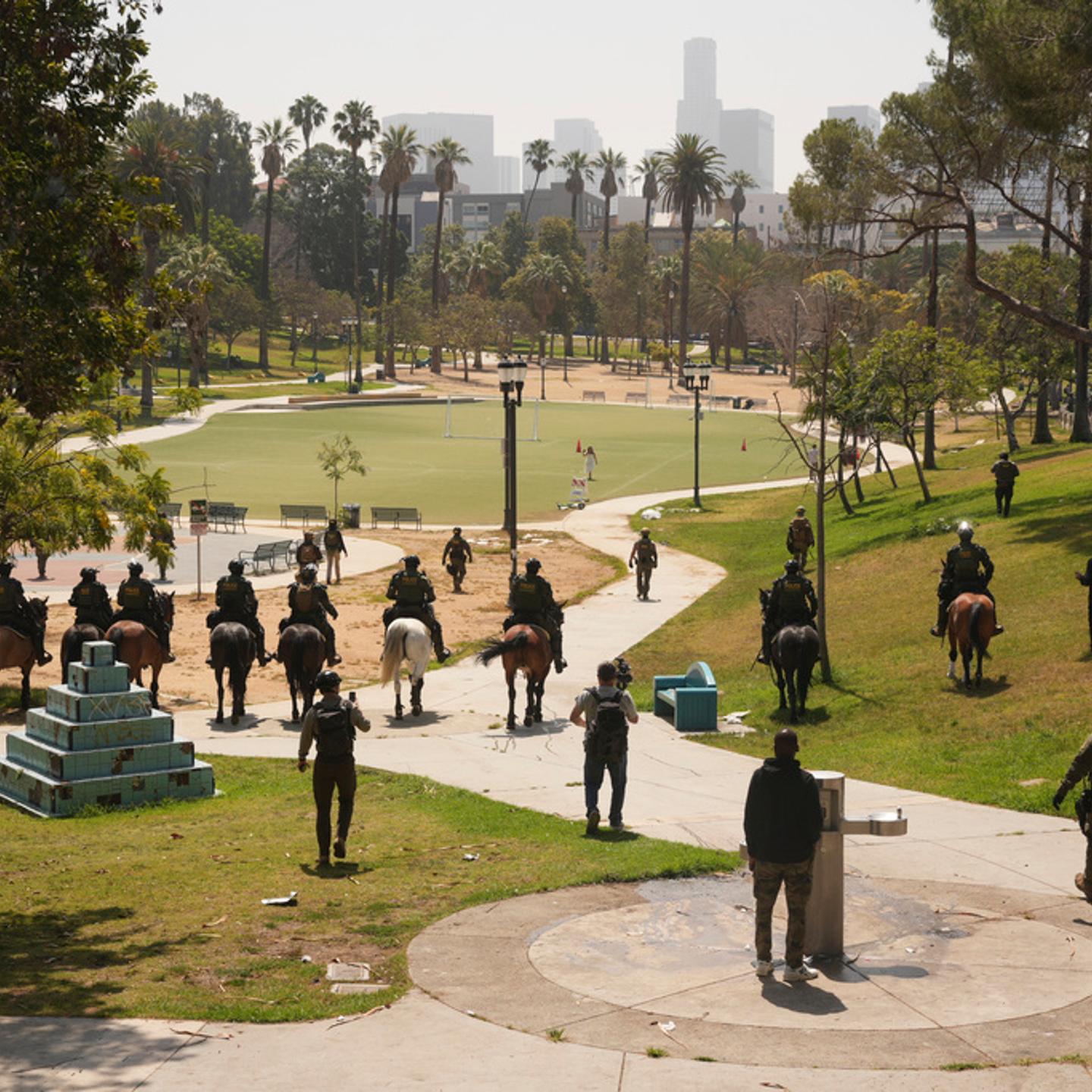Federal agents ride on horseback at MacArthur Park in Los Angeles on July 7, 2025.