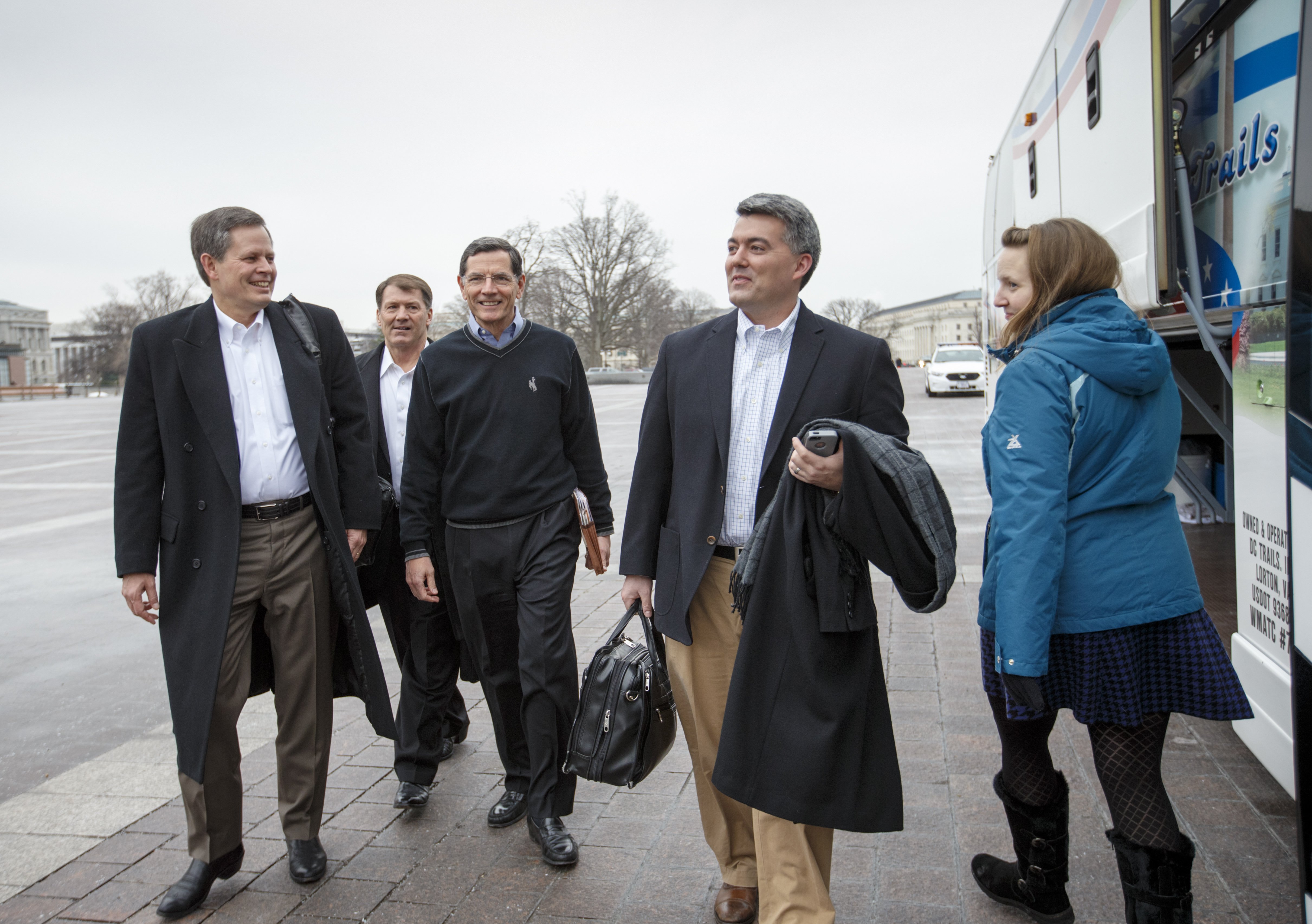 From left, Sen. Steve Daines, R-Mont., Sen. Mike Rounds, R-S.D., Sen. John Barrasso, R-Wyo., and Sen. Cory Gardner, R-Colo., prepare to board a tour bus to join Senate and House Republicans at a two-day policy retreat in Hershey, Pa. on Jan. 14, 2015, in