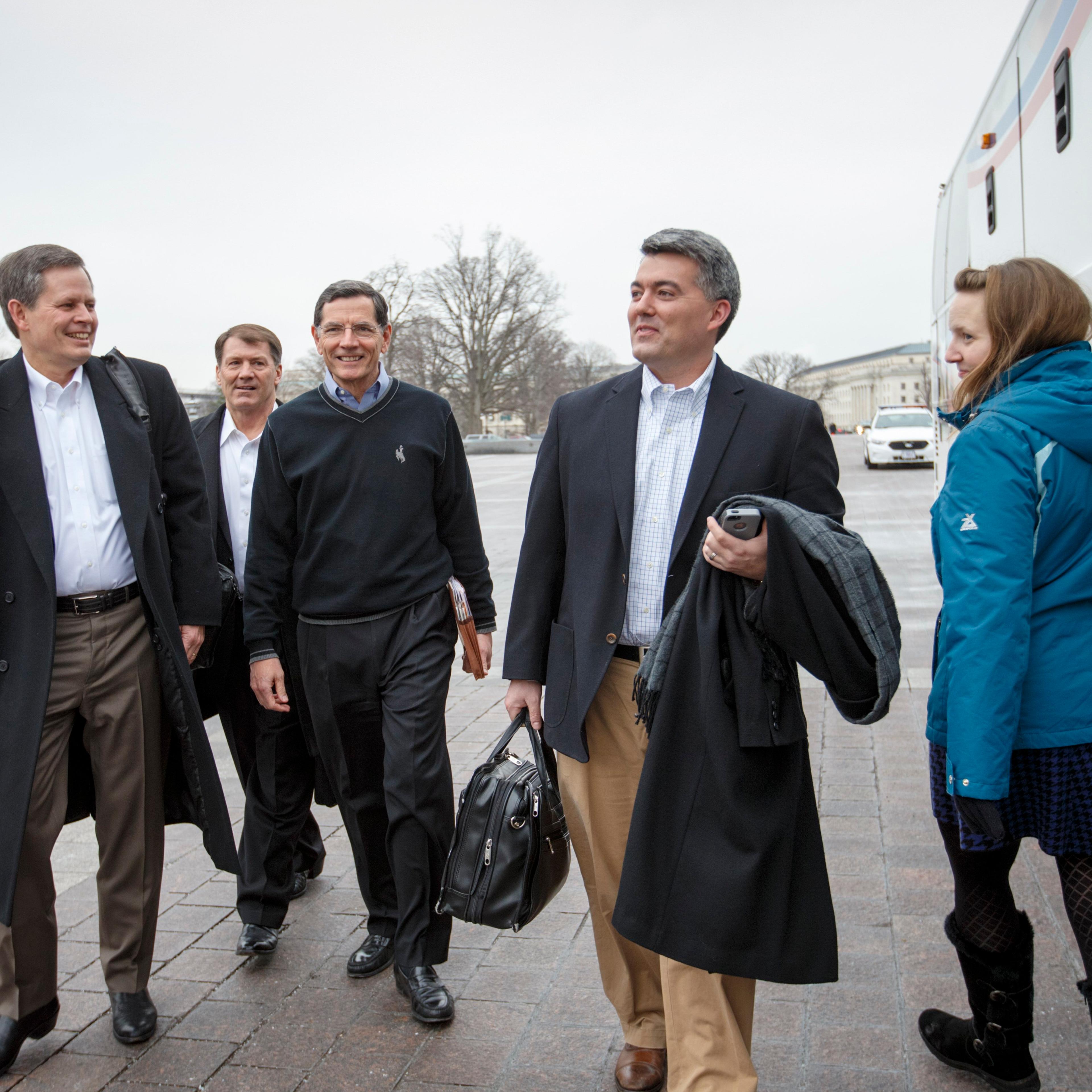 From left, Sen. Steve Daines, R-Mont., Sen. Mike Rounds, R-S.D., Sen. John Barrasso, R-Wyo., and Sen. Cory Gardner, R-Colo., prepare to board a tour bus to join Senate and House Republicans at a two-day policy retreat in Hershey, Pa. on Jan. 14, 2015, in