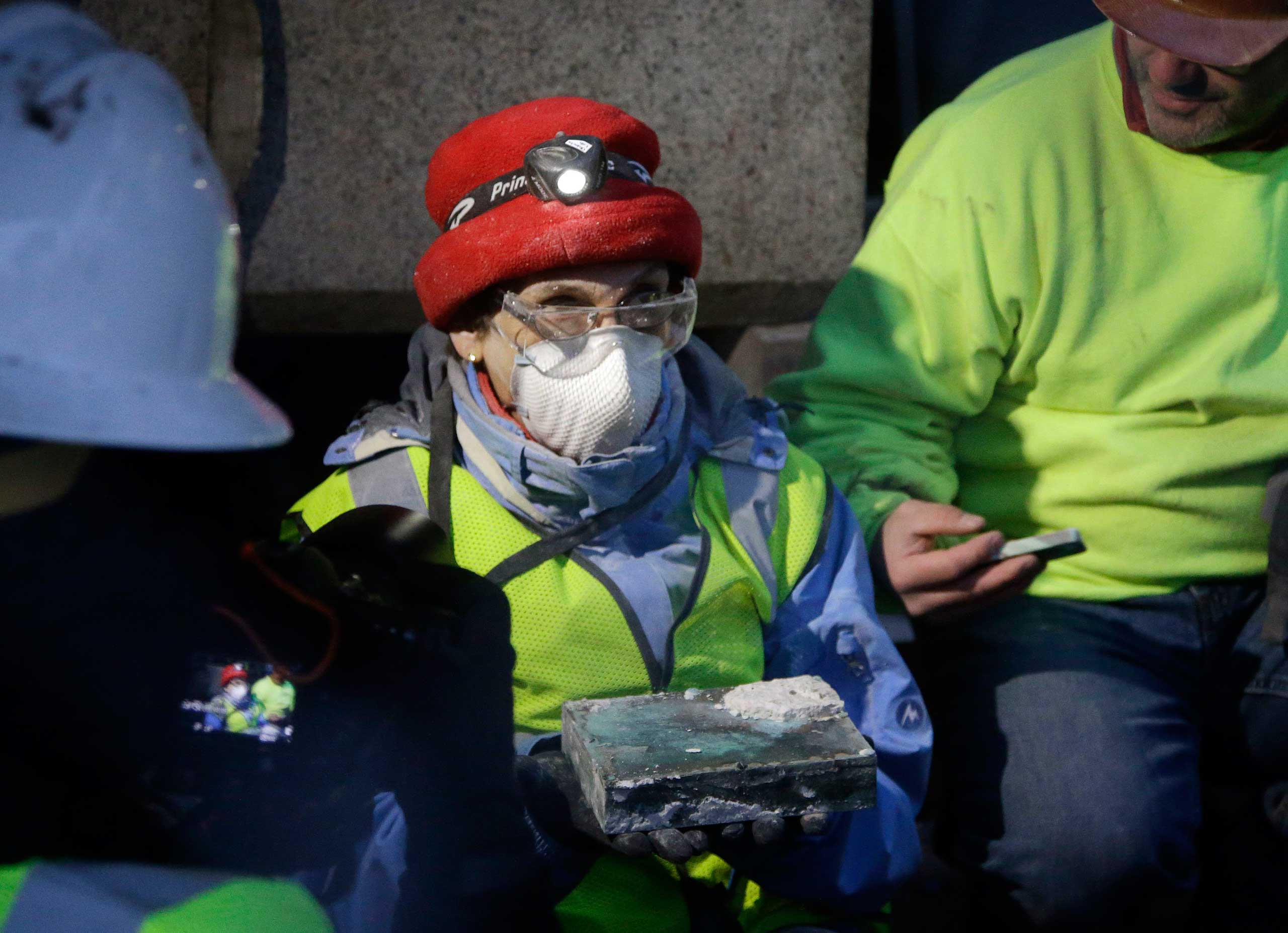 Pamela Hatchfield, a conservator at the Boston's Museum of Fine Arts, holds a time capsule she had just removed from the cornerstone of the Statehouse in Boston,, Dec. 11, 2014.