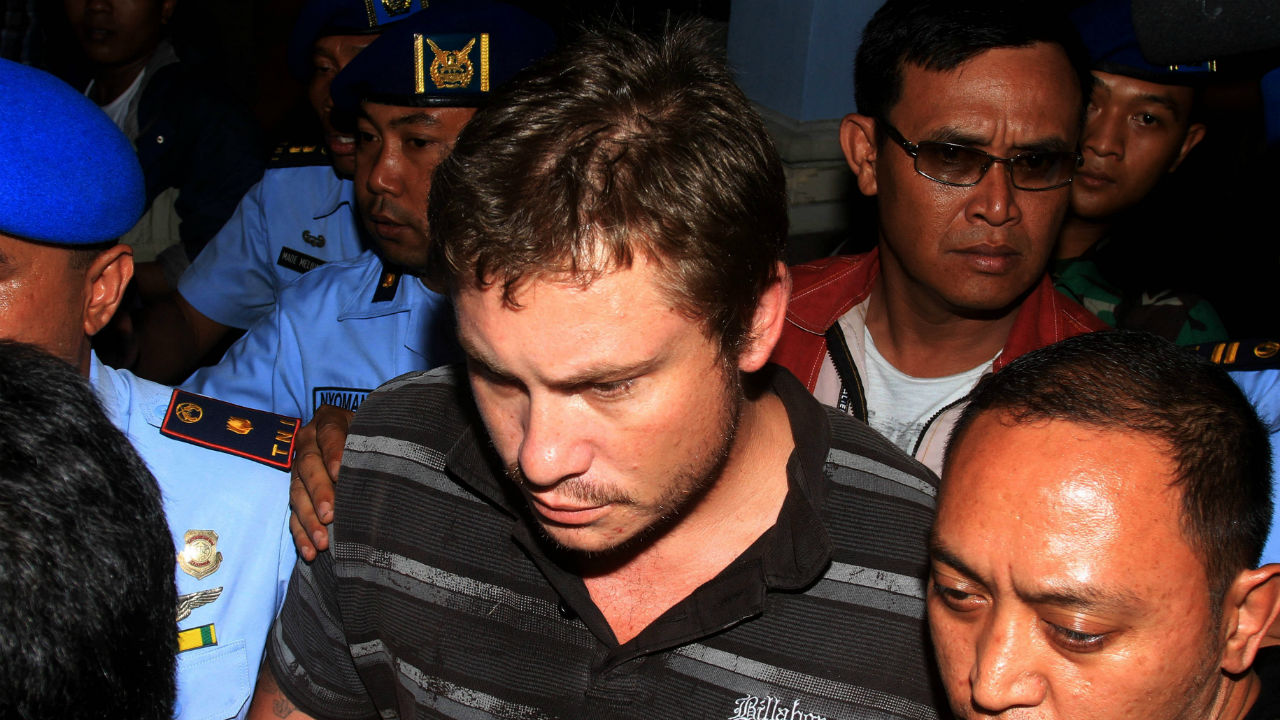 Australian Matt Christopher, 28, a passenger of Virgin Blue Australia Airplane is escorted by Indonesian Air Force army personnel at Ngurah Rai International Airport in Kuta, Bali April 25th 2014