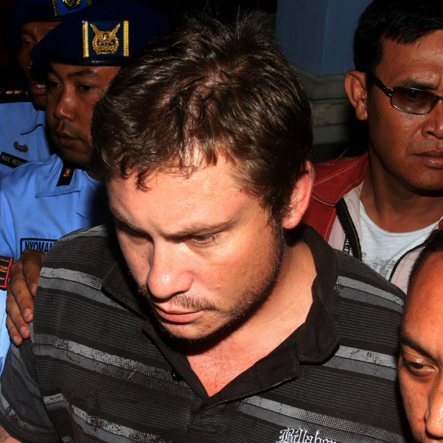Australian Matt Christopher, 28, a passenger of Virgin Blue Australia Airplane is escorted by Indonesian Air Force army personnel at Ngurah Rai International Airport in Kuta, Bali April 25th 2014