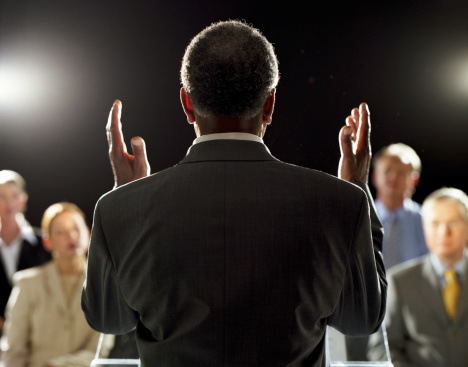 man-giving-speech-rear-view