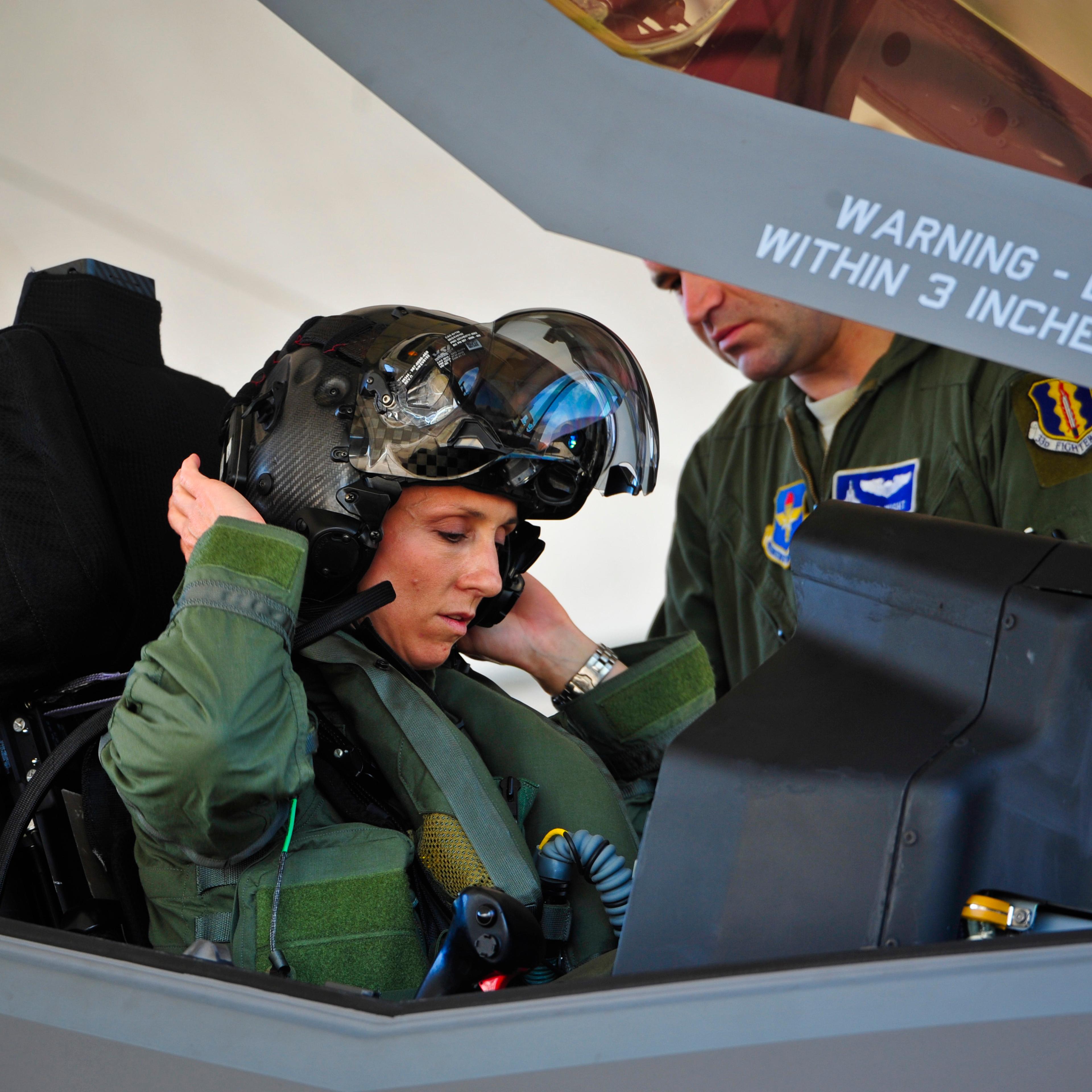 Lt. Col. Christine Mau, 33rd Operations Group deputy commander, puts on her helmet before taking her first flight in the F-35A on Eglin Air Force Base, Fla.