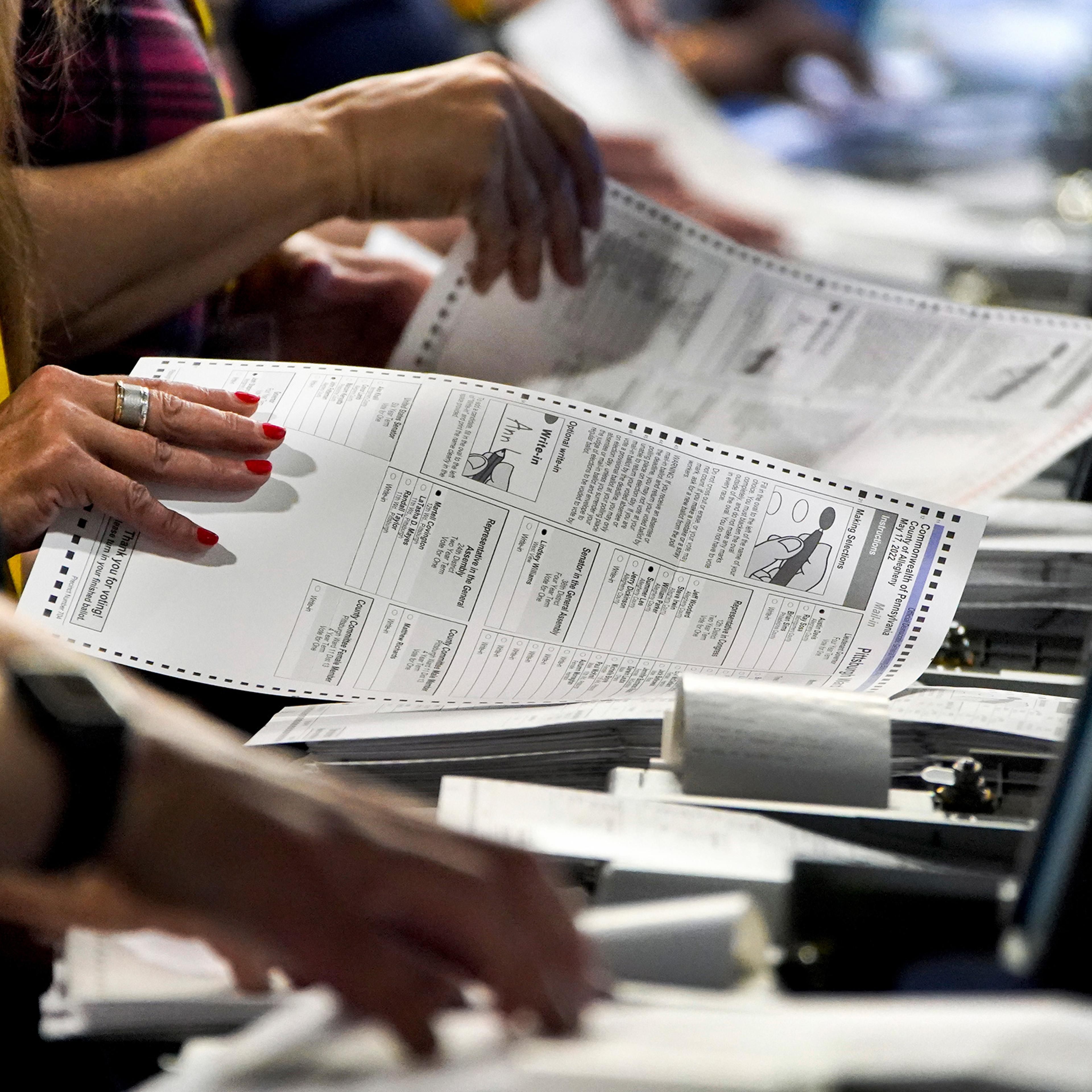 Election workers perform a recount of ballots from the Pennsylvania primary election at the Allegheny County Election Division warehouse in Pittsburgh, Penn., on June 1, 2022.