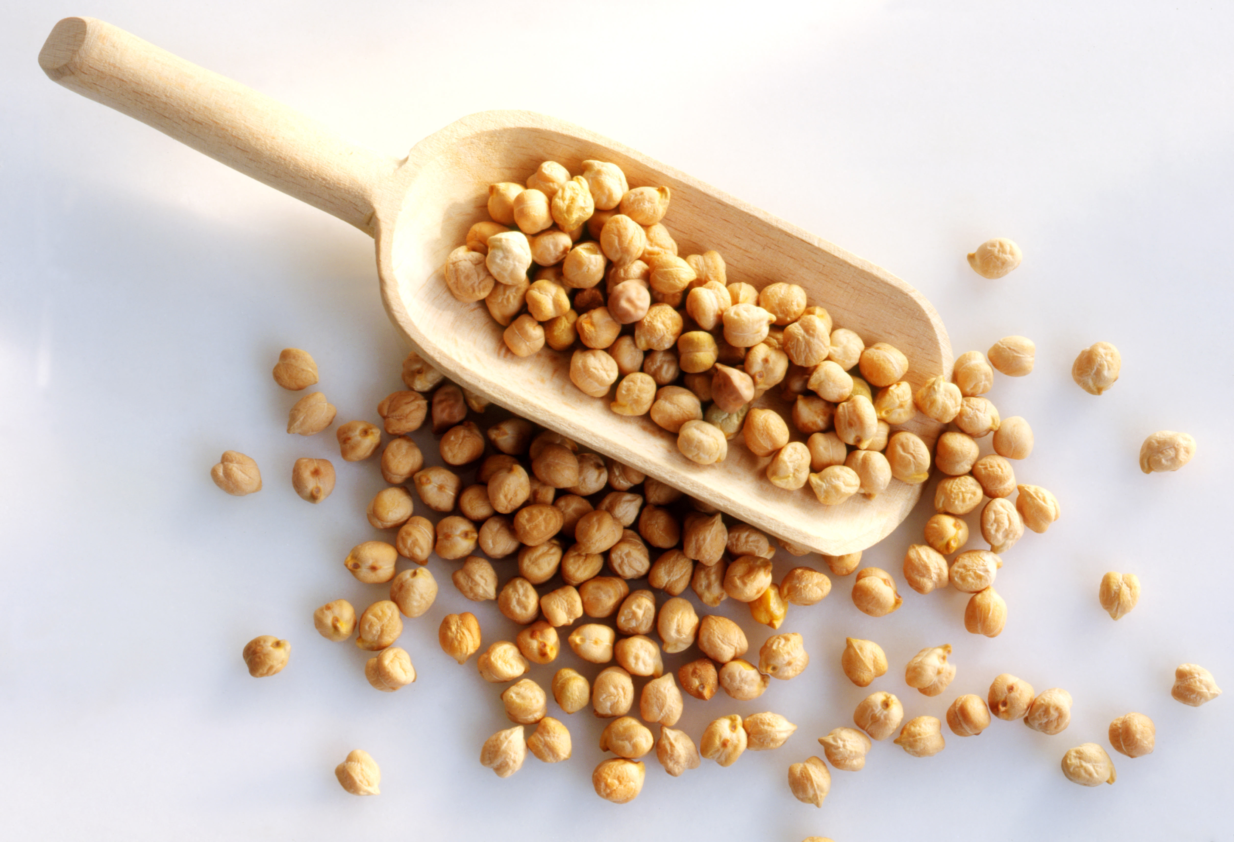 Chickpeas in a wooden scoop
