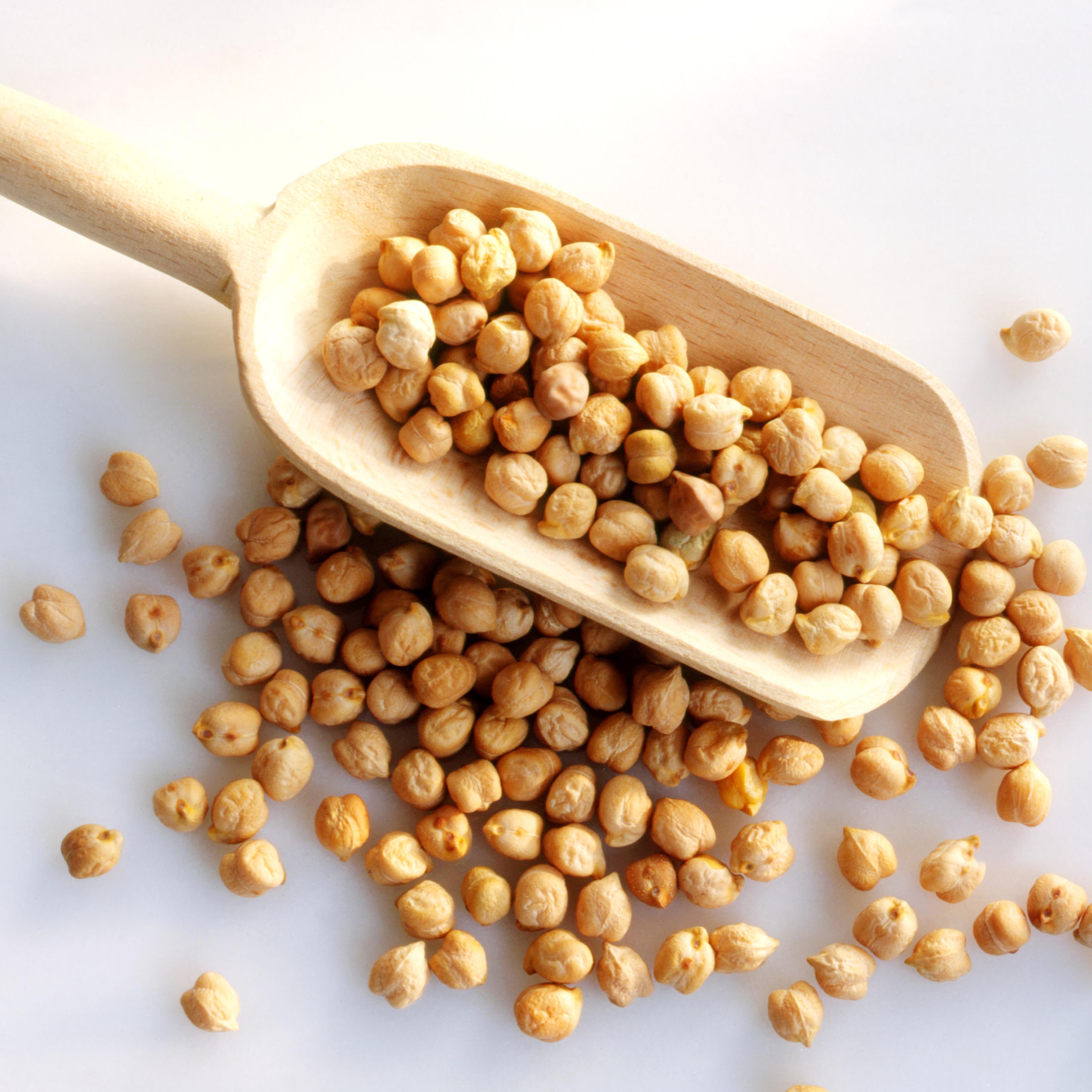 Chickpeas in a wooden scoop