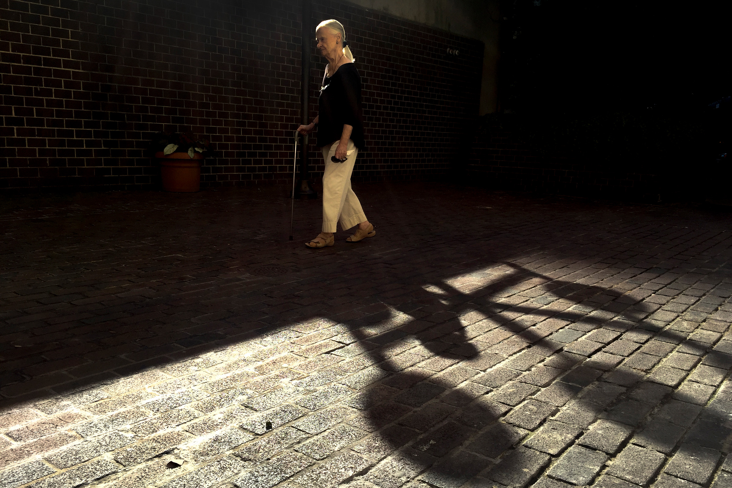 An old woman walks by in New York.