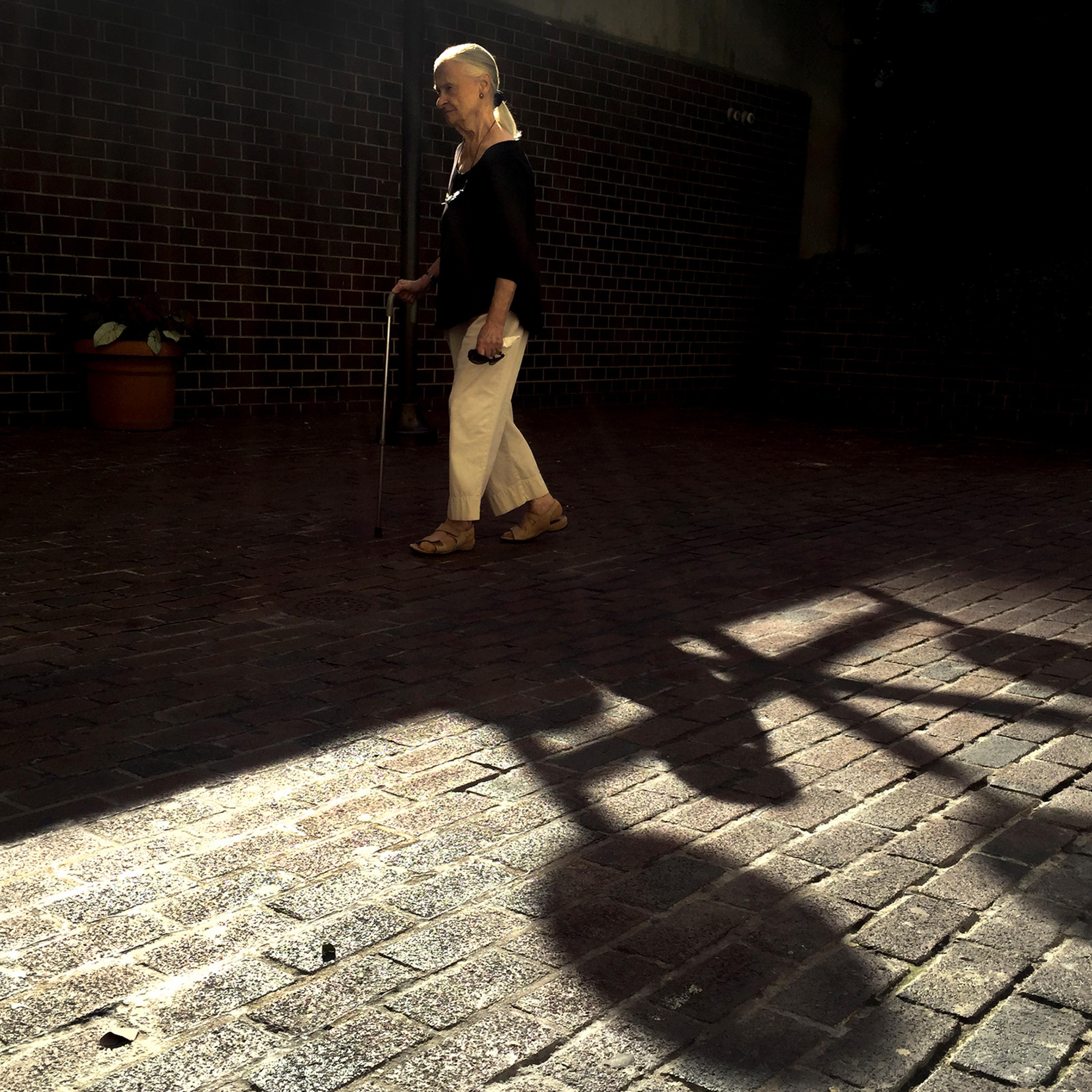 An old woman walks by in New York.