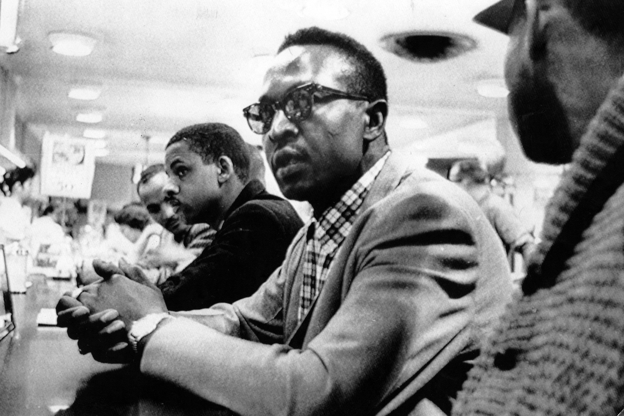 The Greensboro sit-ins, started by four black students from the North Carolina Agricultural and Technical State University, were a peaceful protest of the segregated lunch counter inside the Woolworth store in Greensboro, N.C. in February 1960. The demon