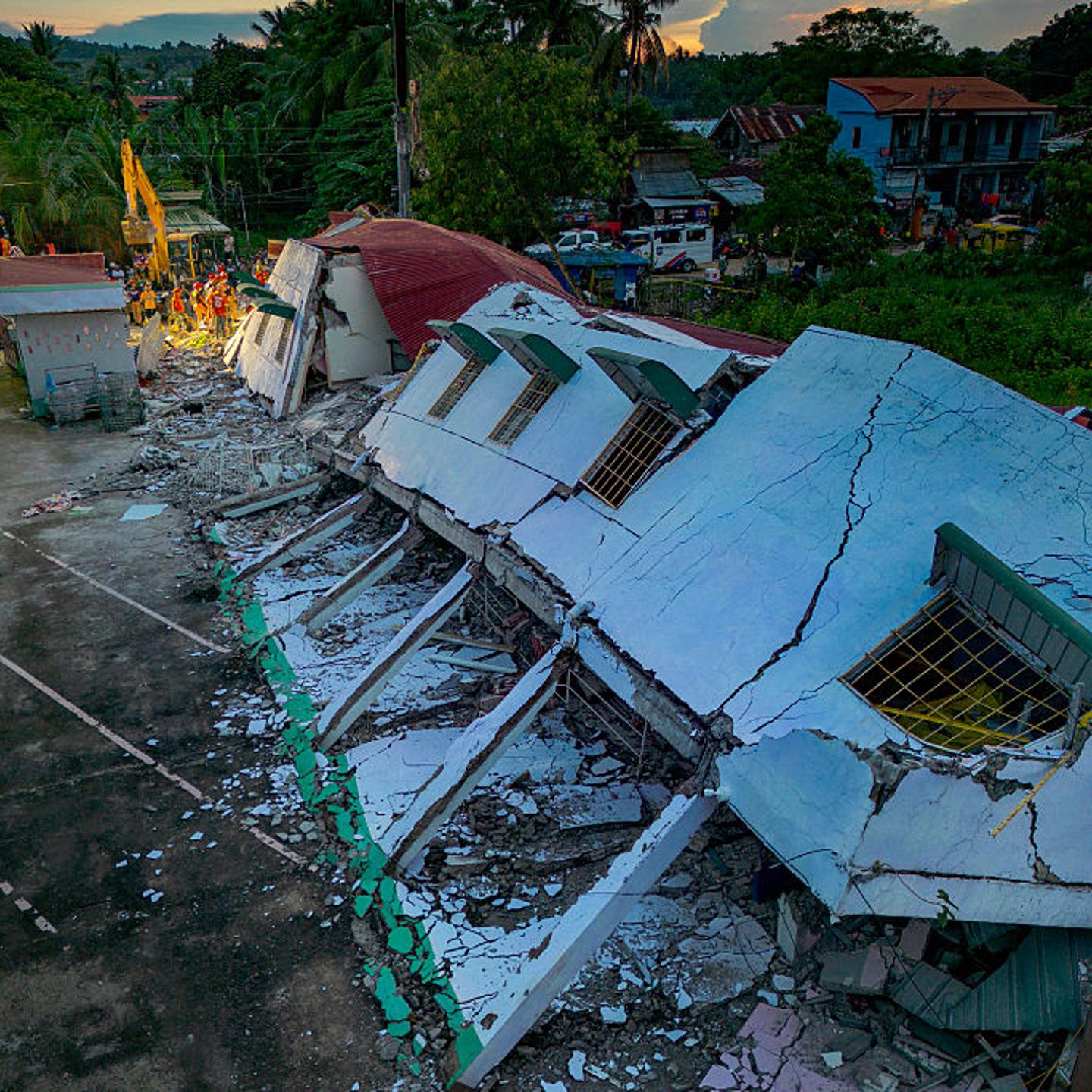 In an aerial view, rescue workers search for survivors under the rubble of a collapsed residential building in Bogo, Cebu province, Philippines, on Oct. 1, 2025.