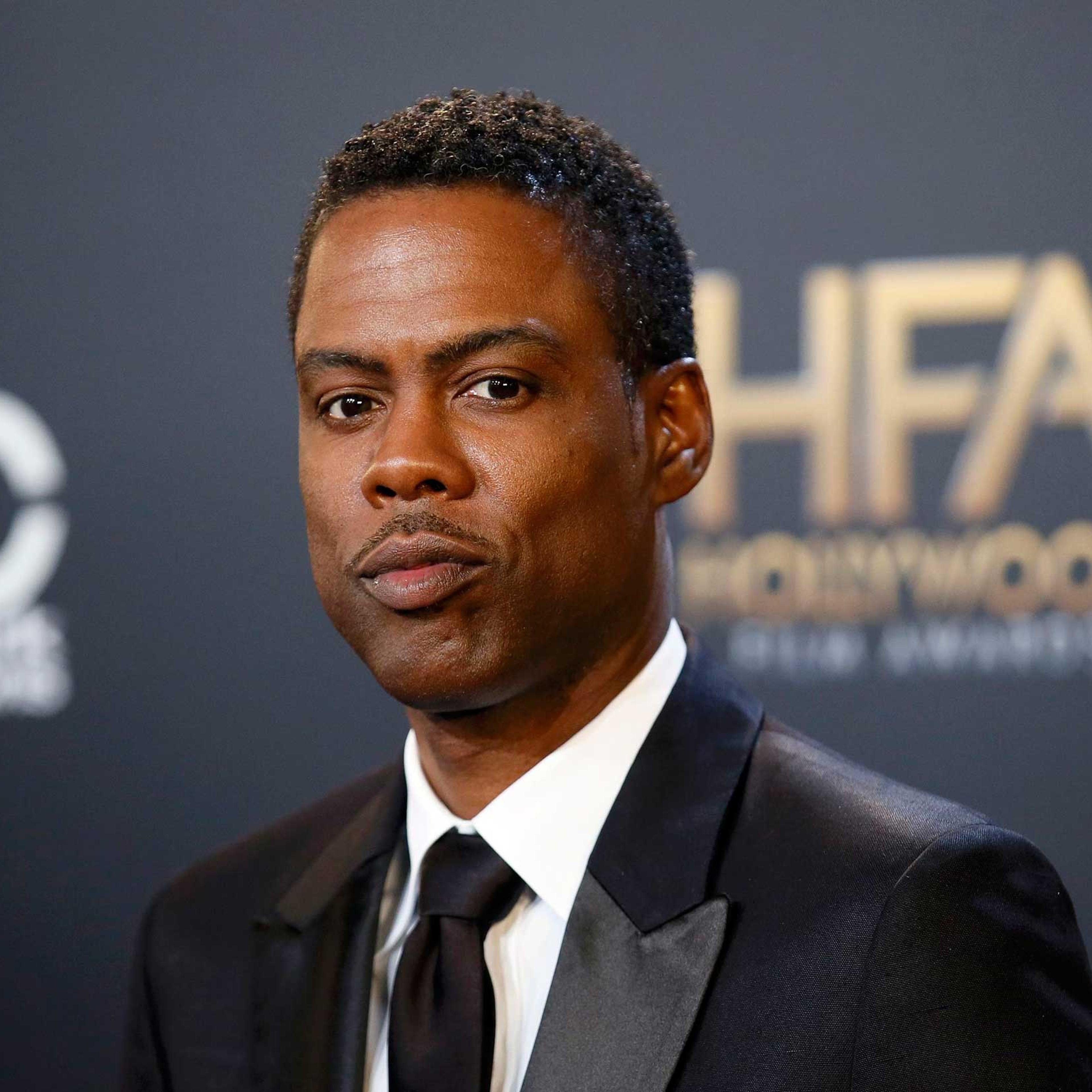 Chris Rock poses with his award during the Hollywood Film Awards in Hollywood