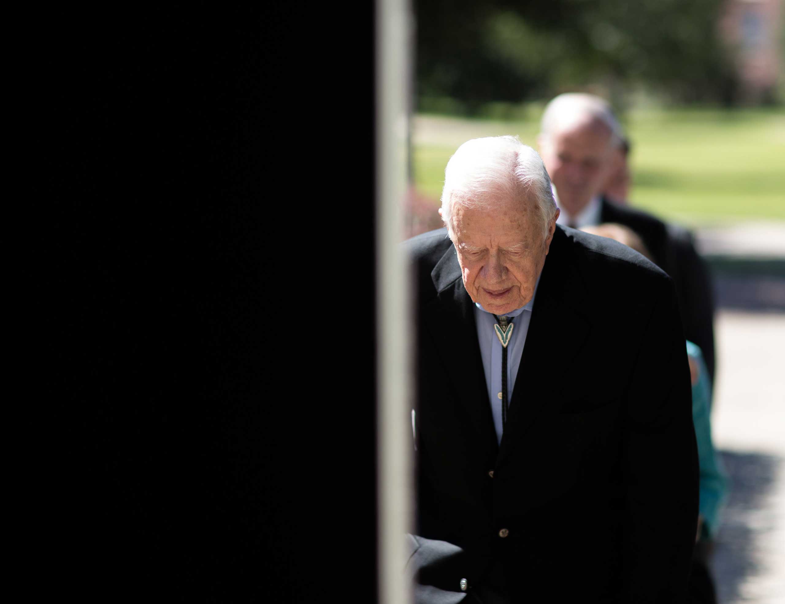 Former President Jimmy Carter enters Jackson Performance Hall at Georgia Southwestern University for his 90th birthday celebration, Oct. 4, 2014, in Americus, Ga.