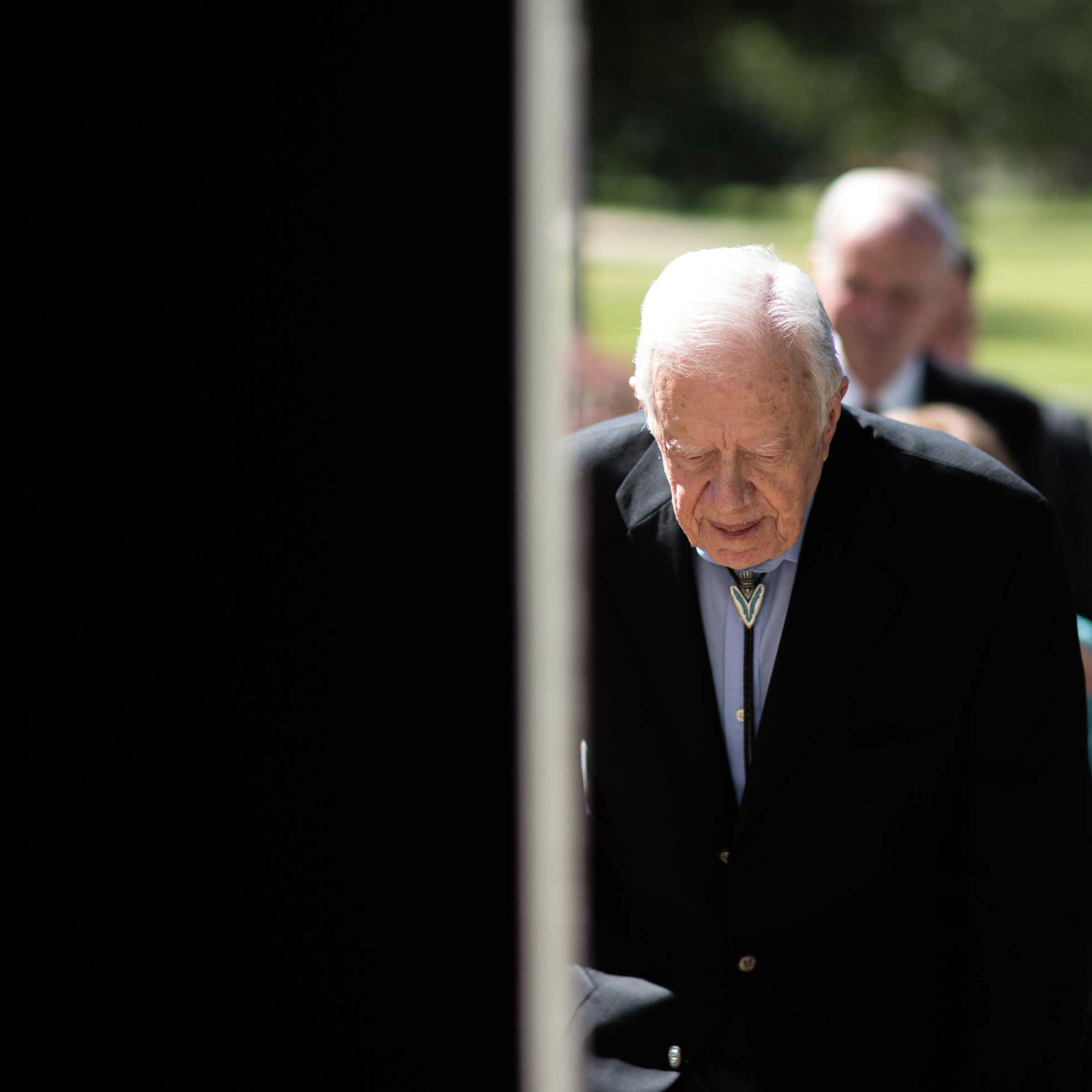 Former President Jimmy Carter enters Jackson Performance Hall at Georgia Southwestern University for his 90th birthday celebration, Oct. 4, 2014, in Americus, Ga.