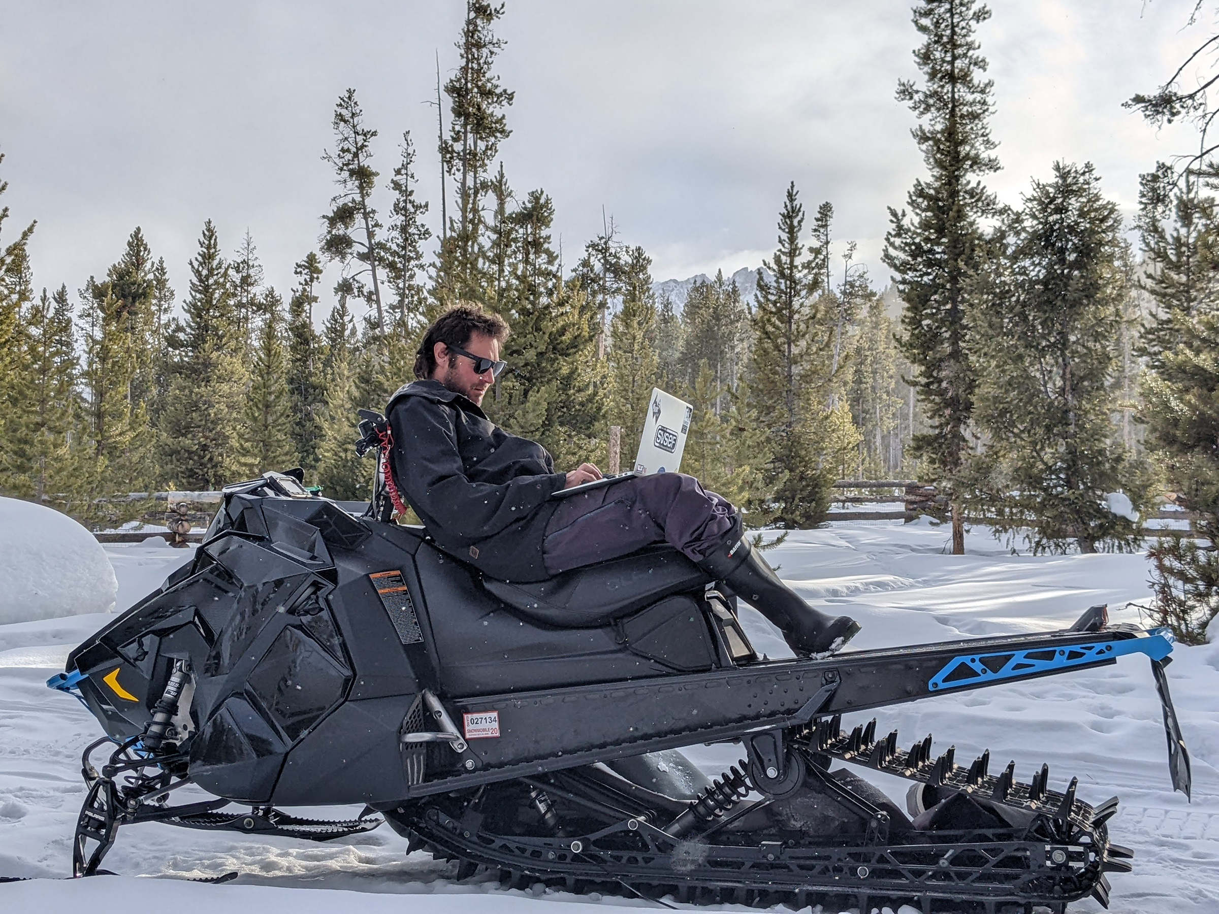 Conor Davis was able to leave his job as a ski coach thanks to his investments. He now spends his winters snowmobiling from his cabin in Stanley, ID.