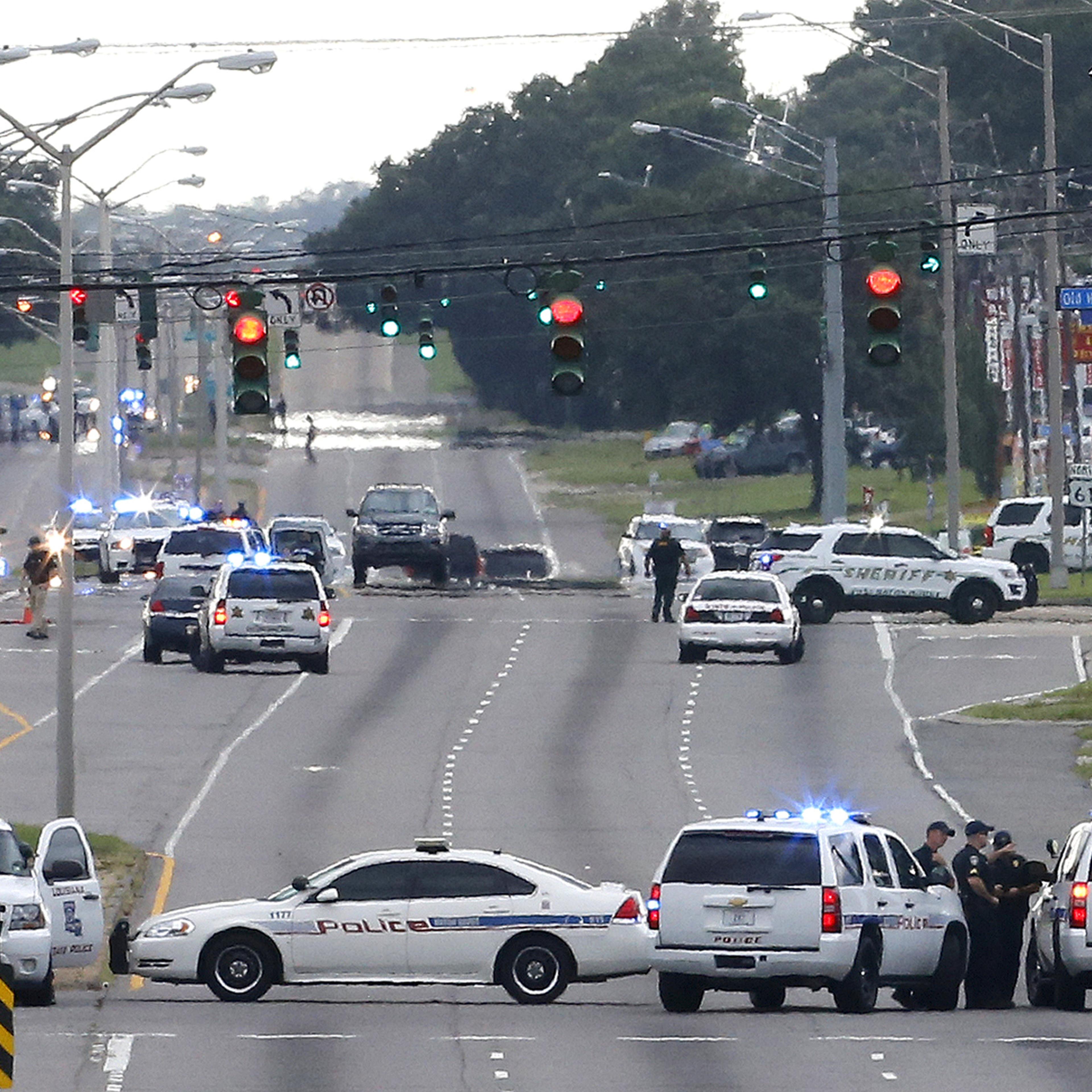 Law enforcement vehicles block access to Airline Highway near the scene of a fatal shooting of police officers in Baton Rouge