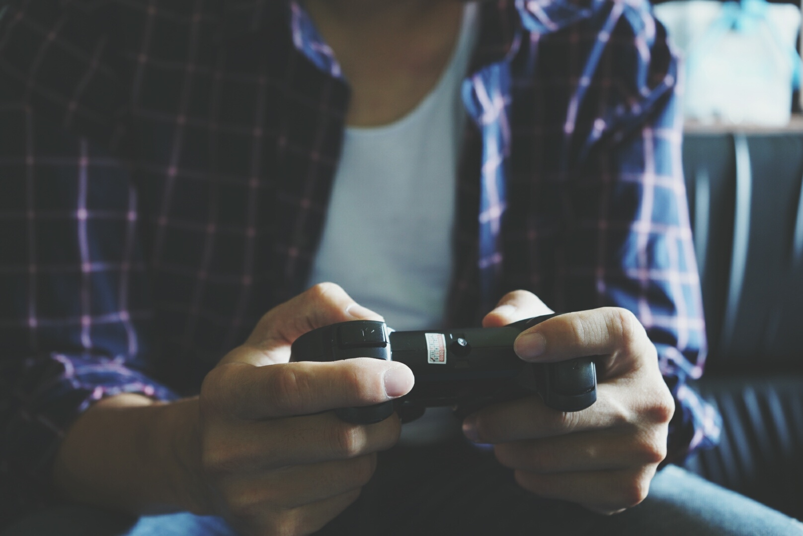 Midsection Of Man Playing Video Game At Home