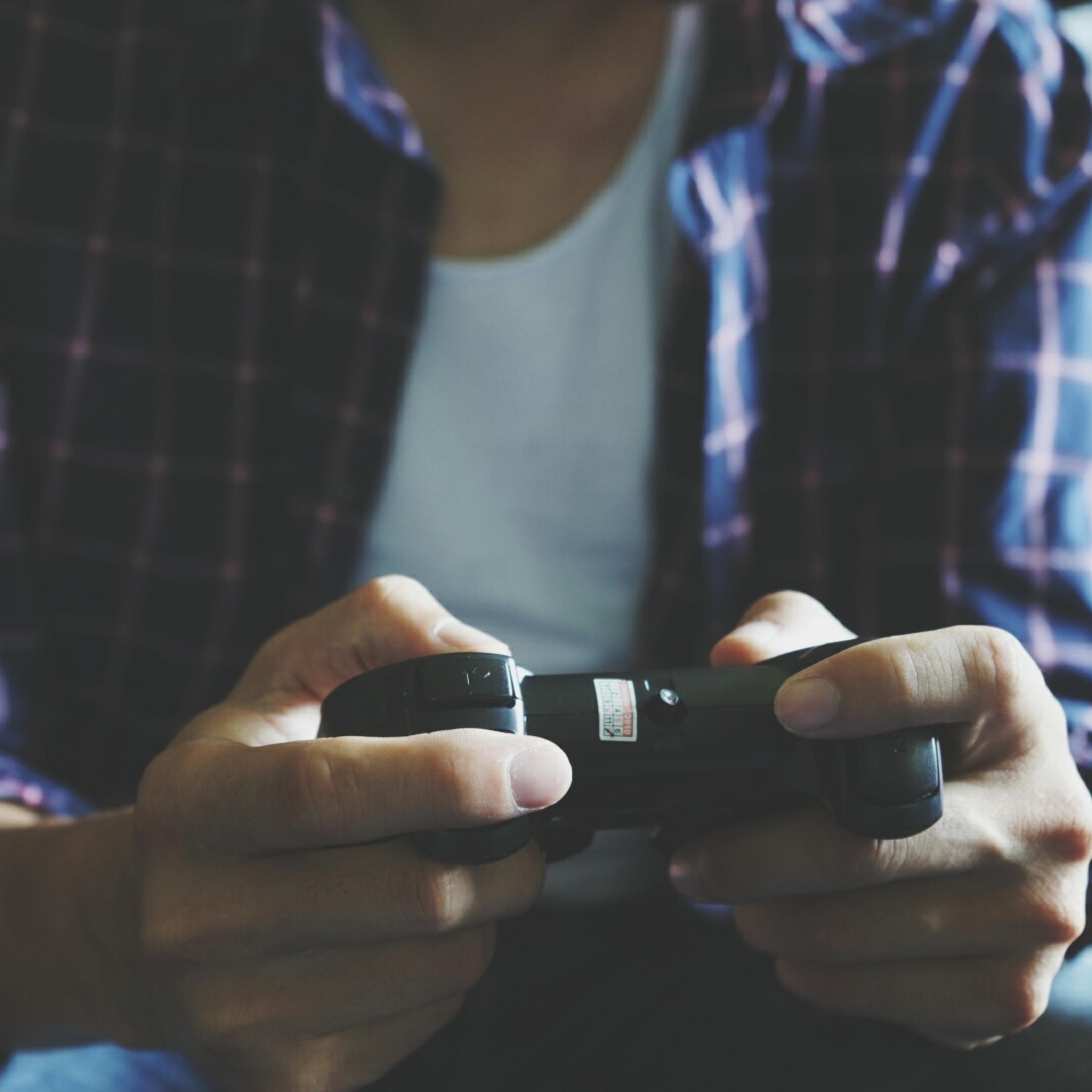 Midsection Of Man Playing Video Game At Home