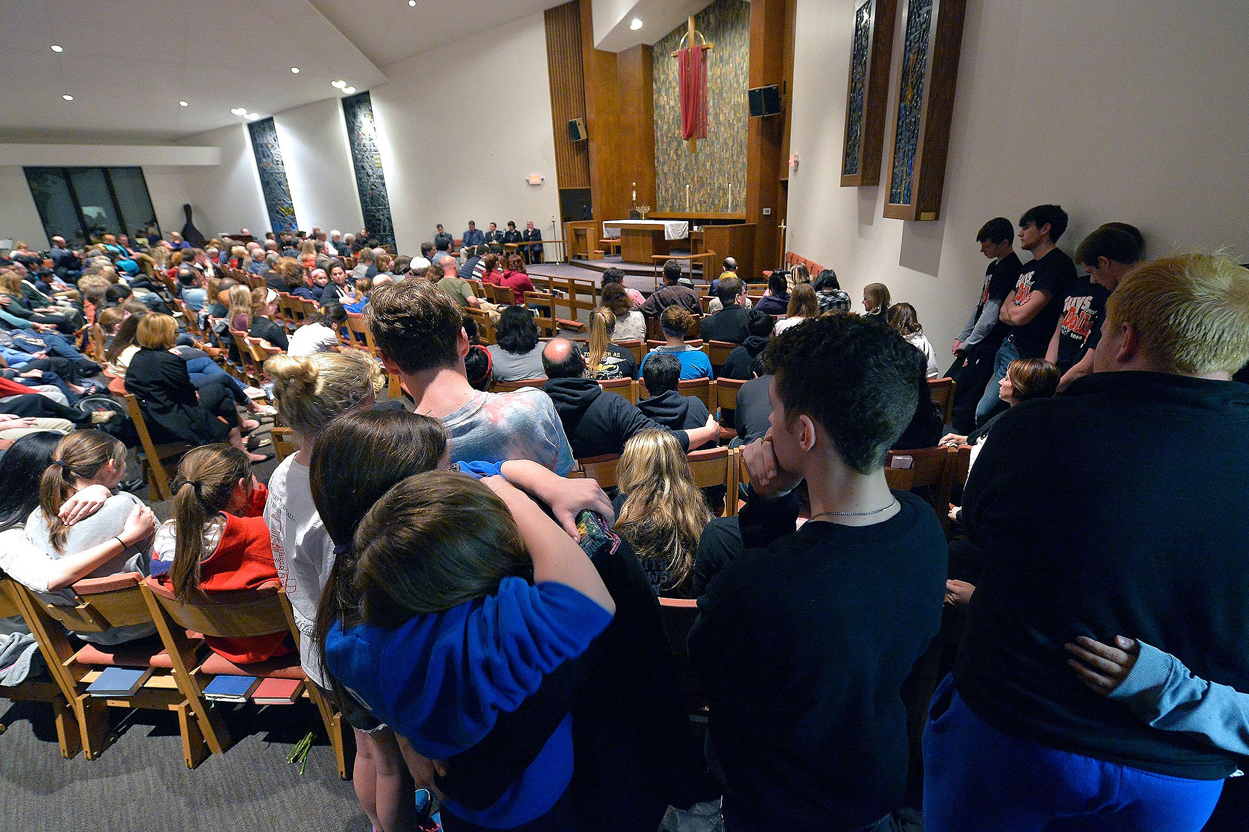 Classmates of one of the victims hug during a prayer service for the victims of the Jewish Community Center shootings in Leawood, Kans., on April 13, 2014