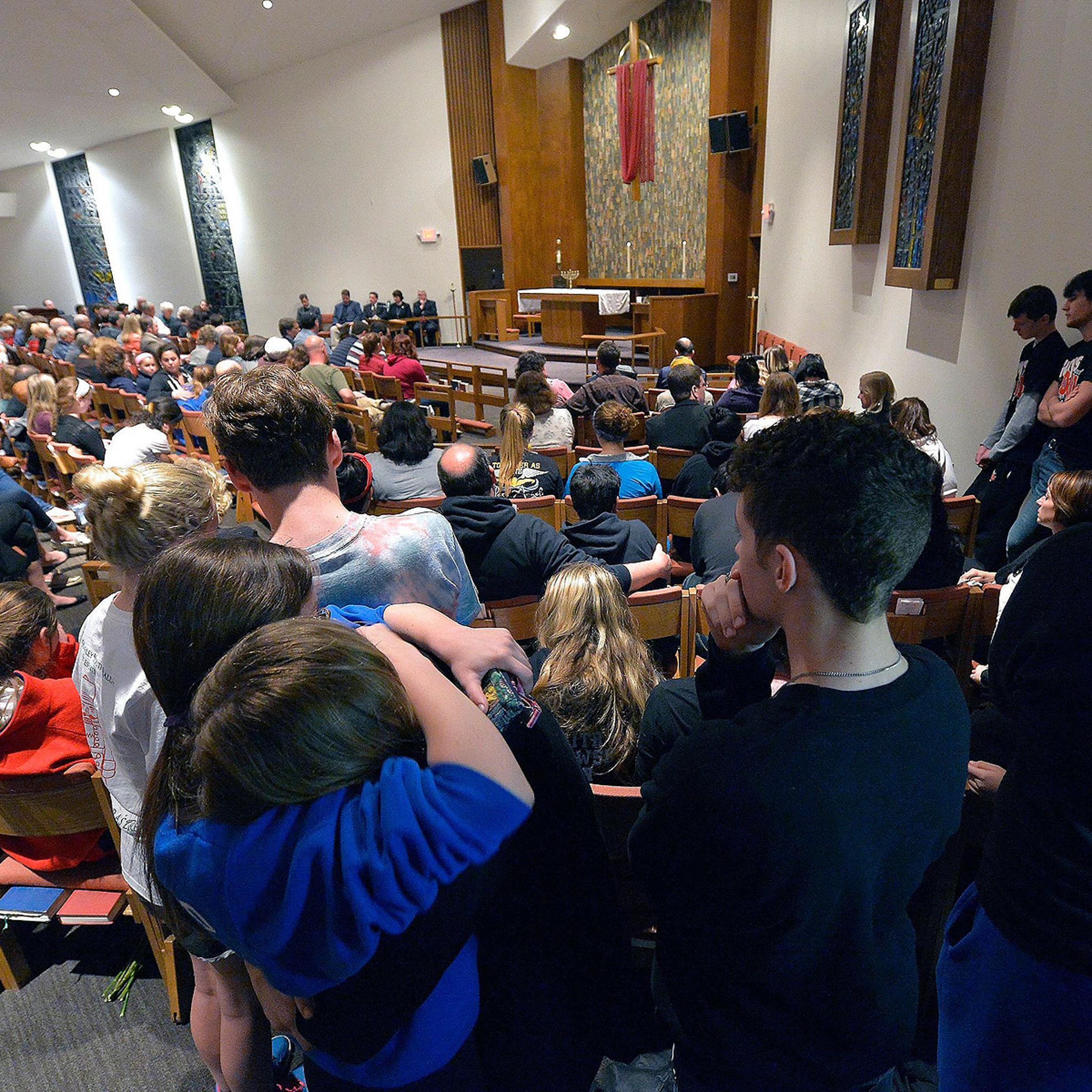 Classmates of one of the victims hug during a prayer service for the victims of the Jewish Community Center shootings in Leawood, Kans., on April 13, 2014