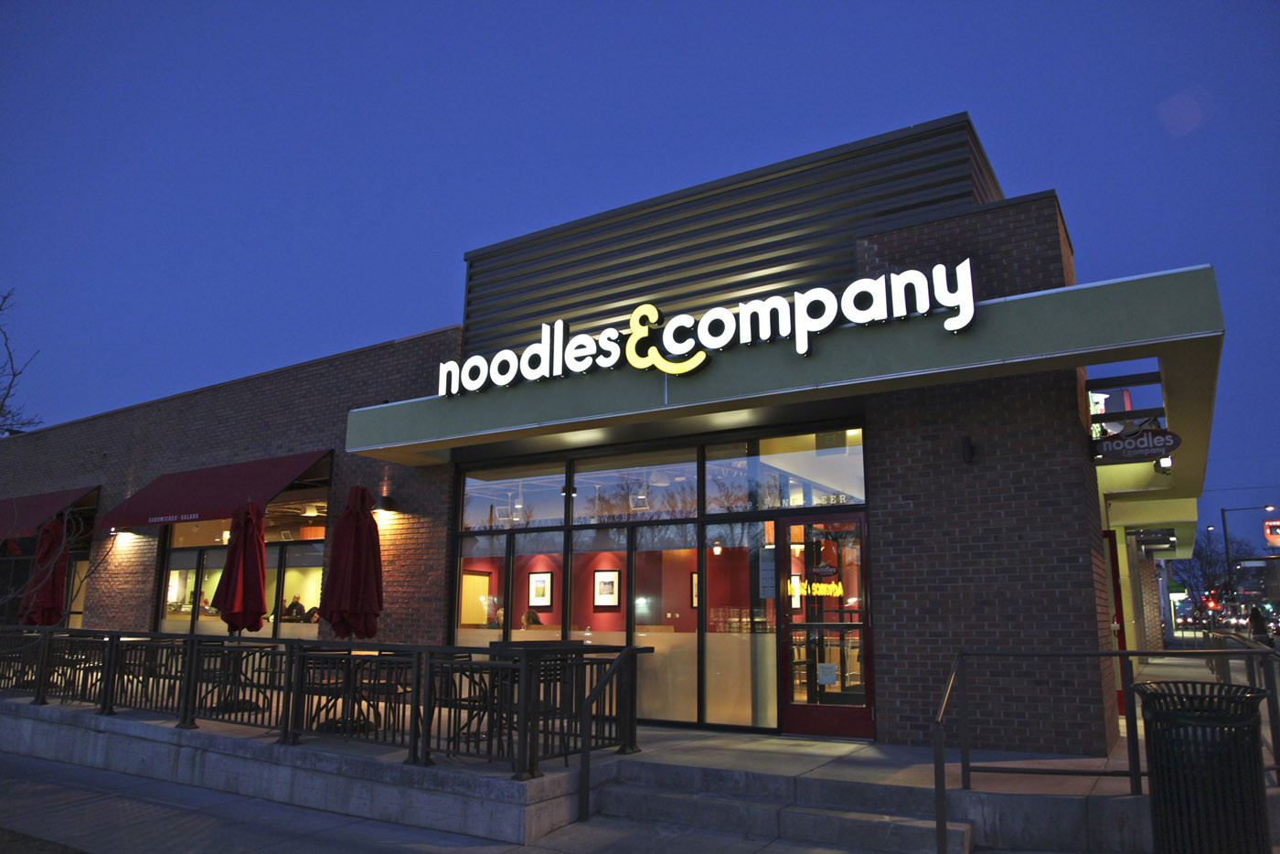 A top Noodles &amp; Co. executive is resigning to become CEO of a hot dog purveyor.