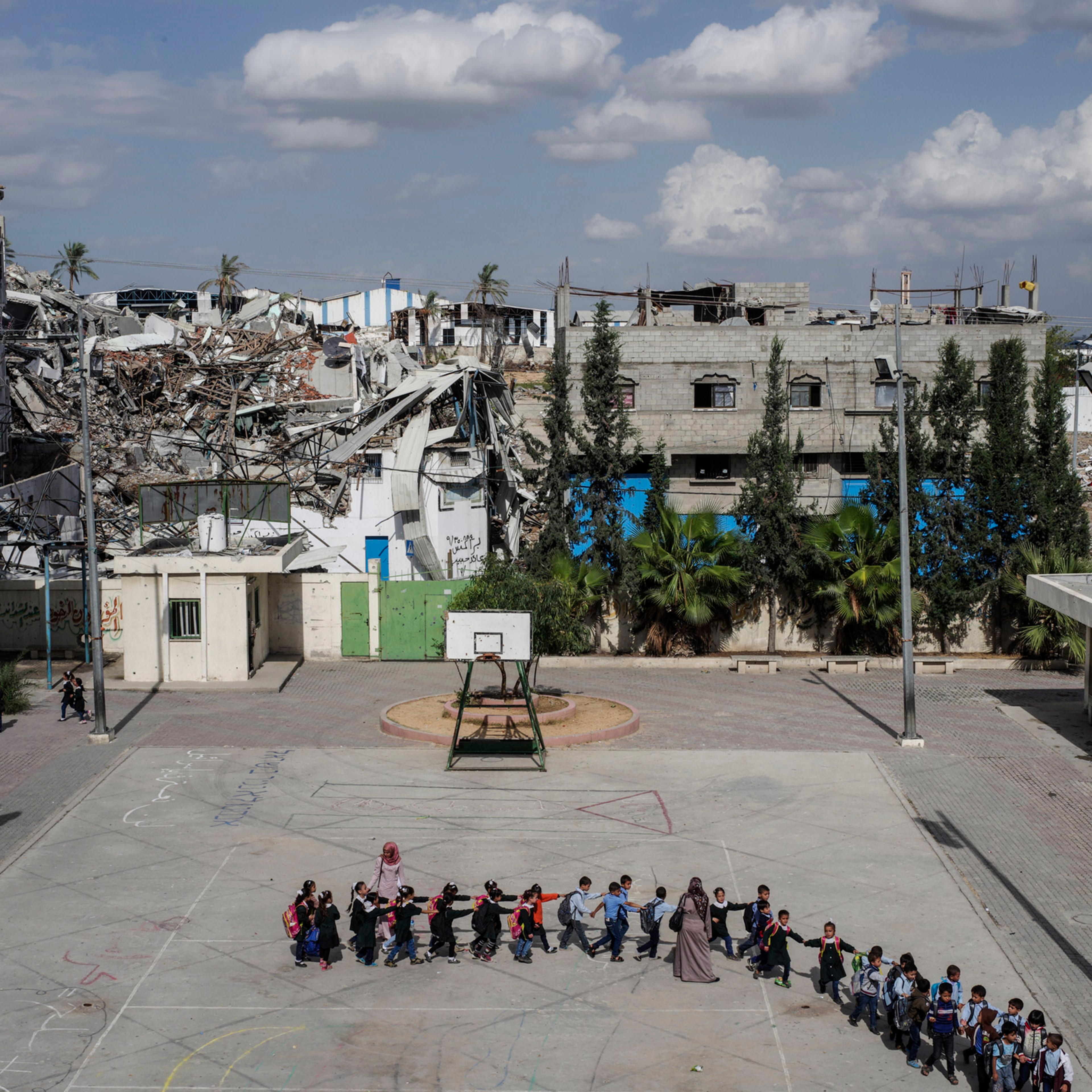 2014. Gaza. Palestine. Schoolchildren head to class at the Sobhi Abu Karsh School in the Shujai'iya neighborhood. Operation Protective Edge lasted from 8 July 2014 – 26 August 2014, killing 2,189 Palestinians of which 1,486 are believed to be civilian
