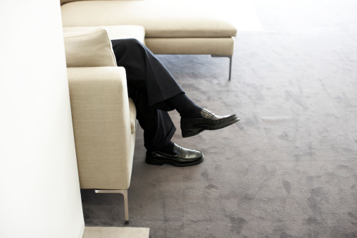 businessman-legs-armchair