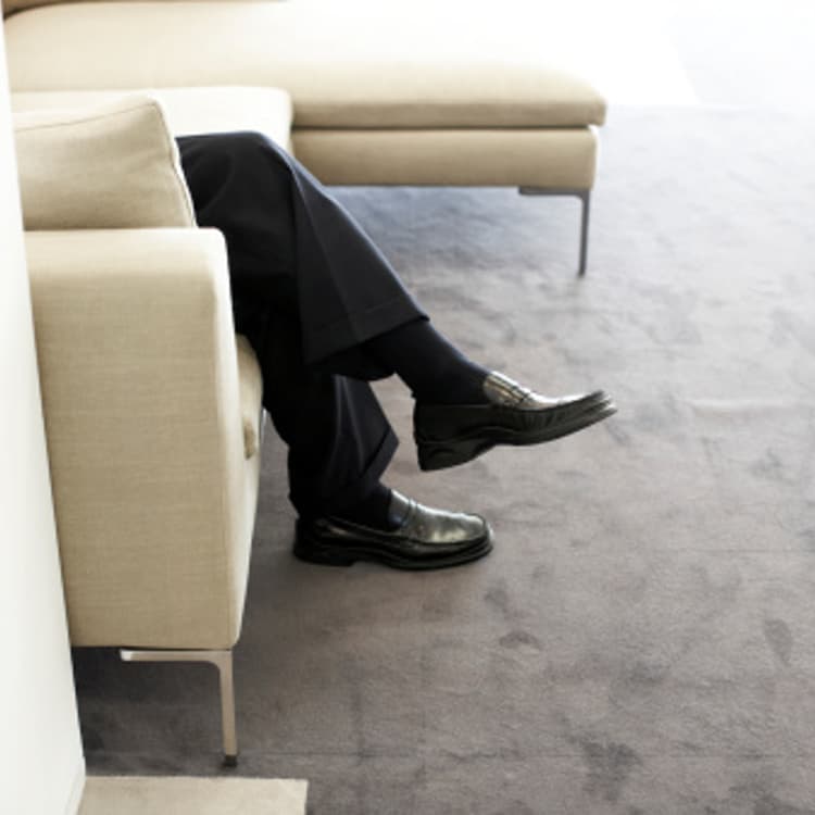 businessman-legs-armchair