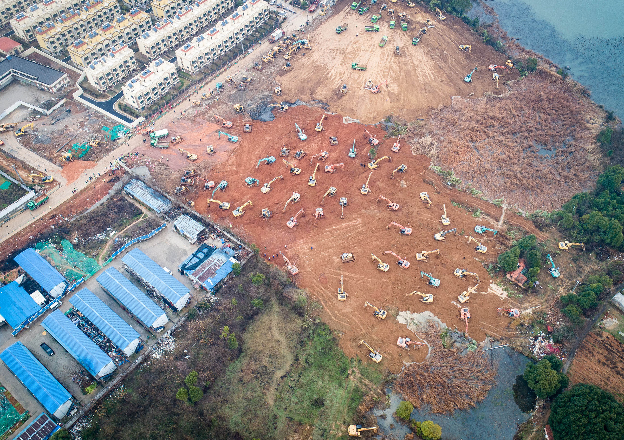 Earth movers build one of two new hospitals the government ordered to treat coronavirus cases in Wuhan