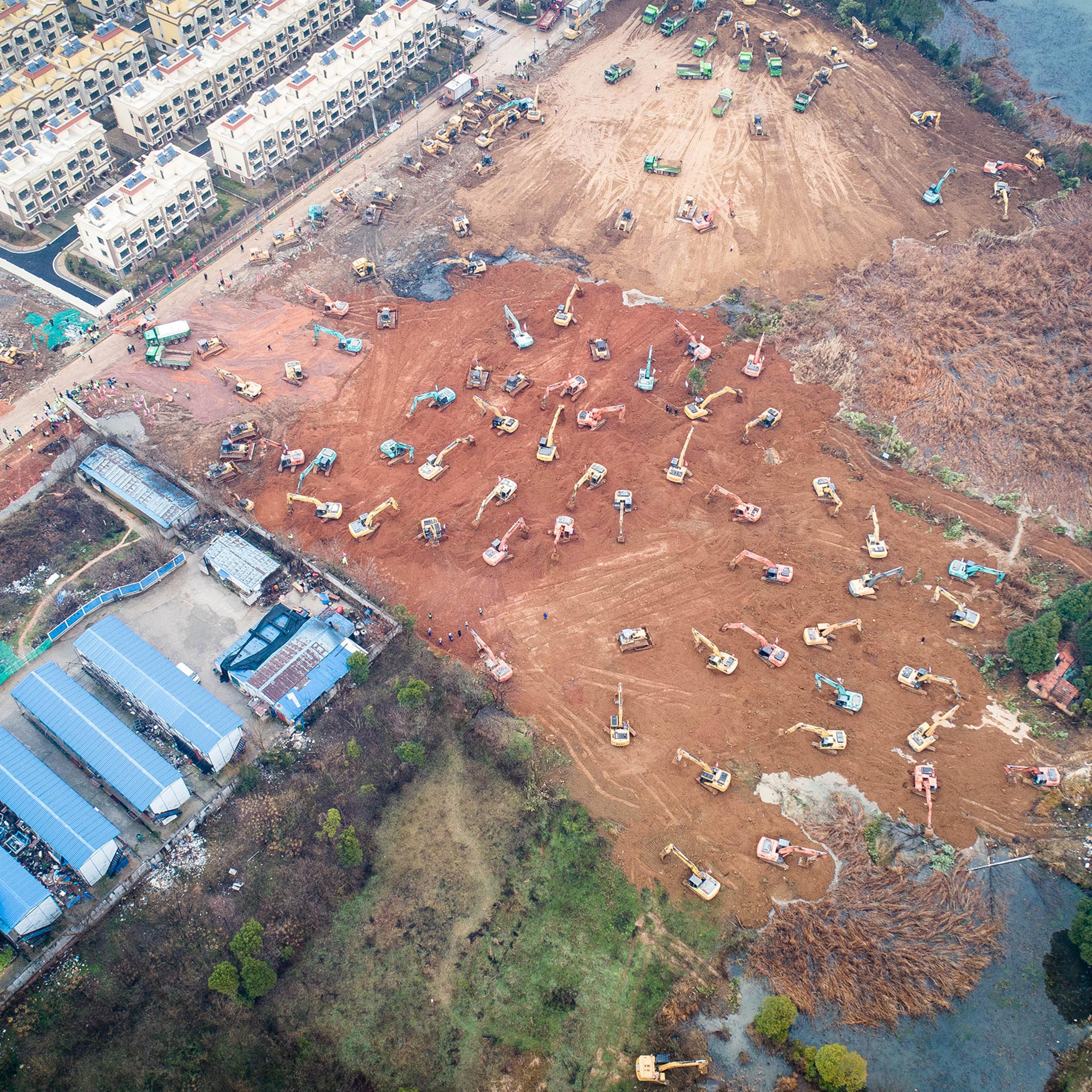 Earth movers build one of two new hospitals the government ordered to treat coronavirus cases in Wuhan