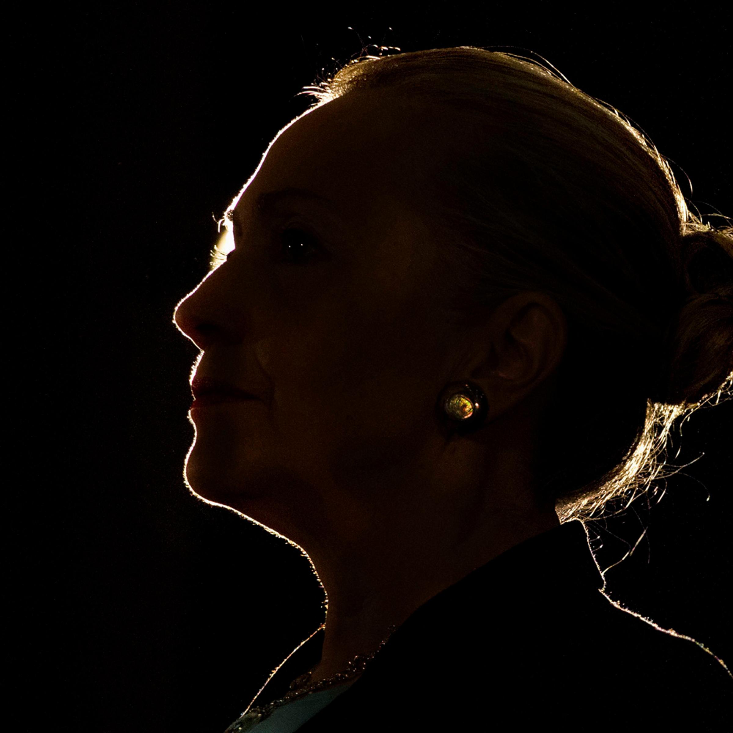 Silhouetted by a stage light, Secretary of State Hillary Rodham Clinton speaks at the University of the Western Cape about U.S.-South Africa partnership, Wednesday, Aug. 8, 2012, in Cape Town, South Africa. (AP Photo/Jacquelyn Martin, Pool)