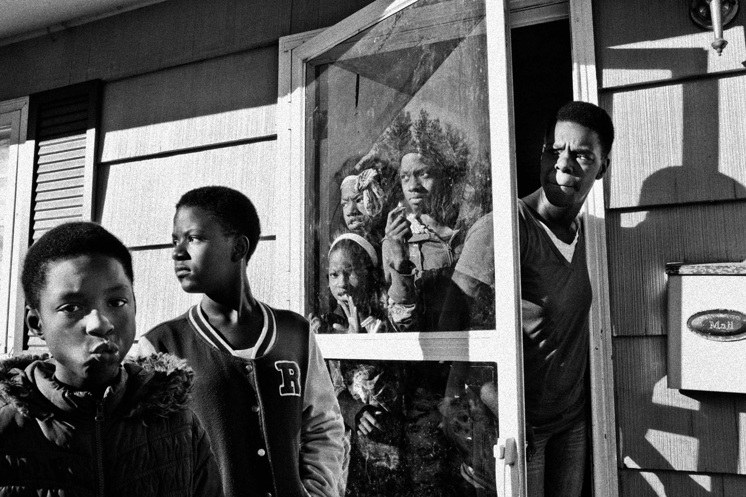 <b>Bloomberg Businessweek: <i>24 Hours in Ferguson — Scenes from the Michael Brown Fallout</i></b><br>Valerie Hopkins, Nija Chatman, Lana Chatman, Shirley Chatman, Jessica Chatman, and Lashanda Chatman (right to left) looking outside as a police car passes their Ferguson, Mo., home the day after massive rioting broke out