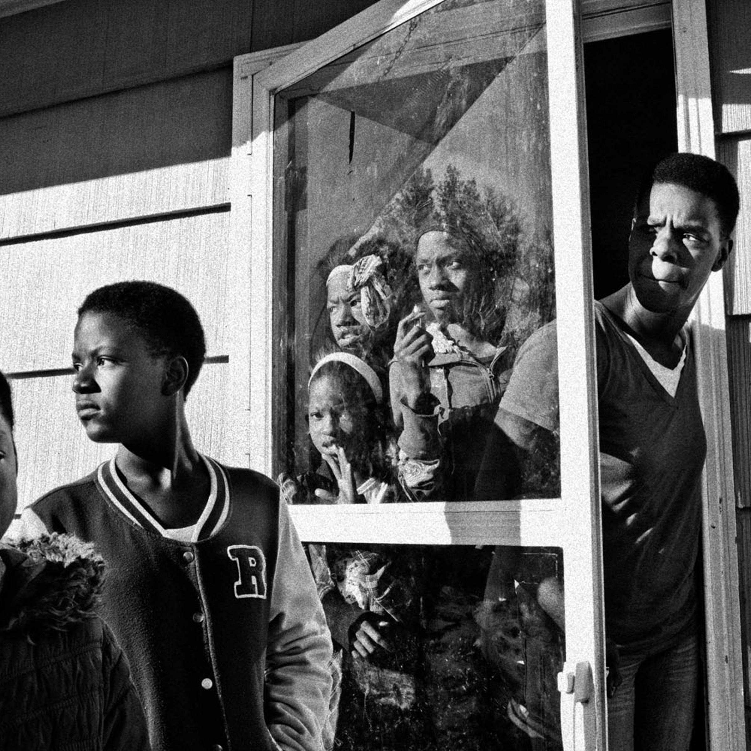 <b>Bloomberg Businessweek: <i>24 Hours in Ferguson — Scenes from the Michael Brown Fallout</i></b><br>Valerie Hopkins, Nija Chatman, Lana Chatman, Shirley Chatman, Jessica Chatman, and Lashanda Chatman (right to left) looking outside as a police car passes their Ferguson, Mo., home the day after massive rioting broke out