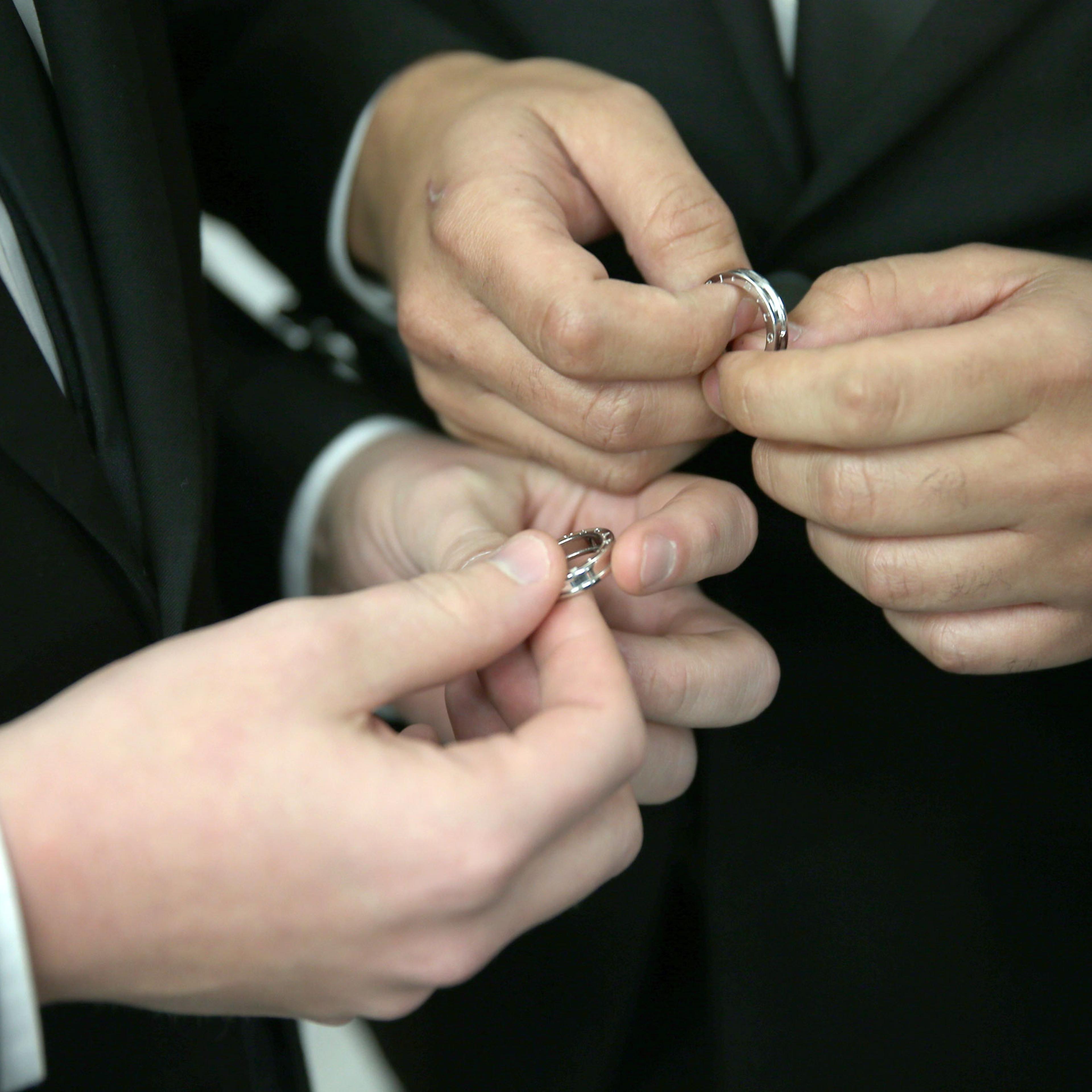 A couple exchange rings as they are wed during a wedding ceremony at the Broward County Courthouse on Jan. 6, 2015 in Fort Lauderdale, Fla