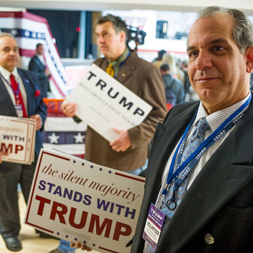 Campaign volunteer George Vazquez, hands out signs to supporters before a Donald Trump campaign rally at Stevens High School on January 5, 2016, in Claremont, New Hampshire.