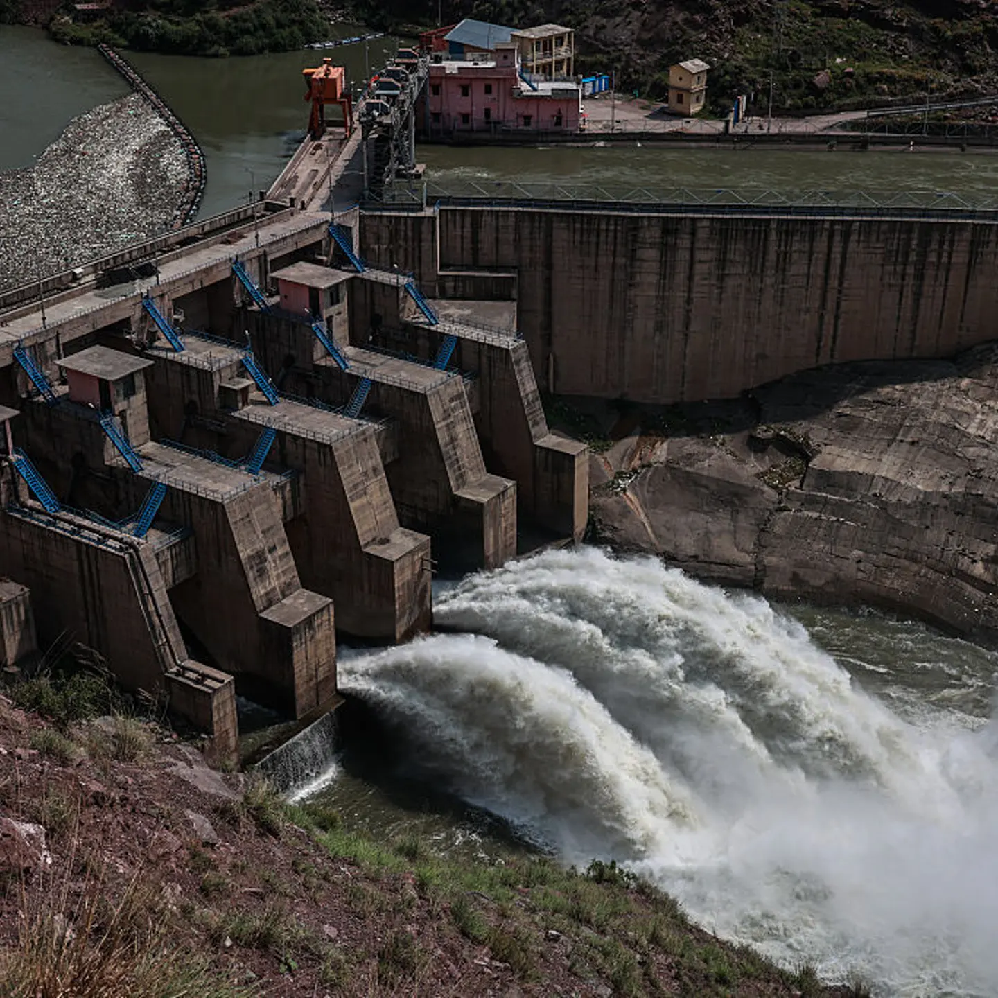 Water flows from the Lower Jhelum Hydel Project Dam over the Jhelum River in Baramulla, Jammu and Kashmir, India, on May 6, 2025.