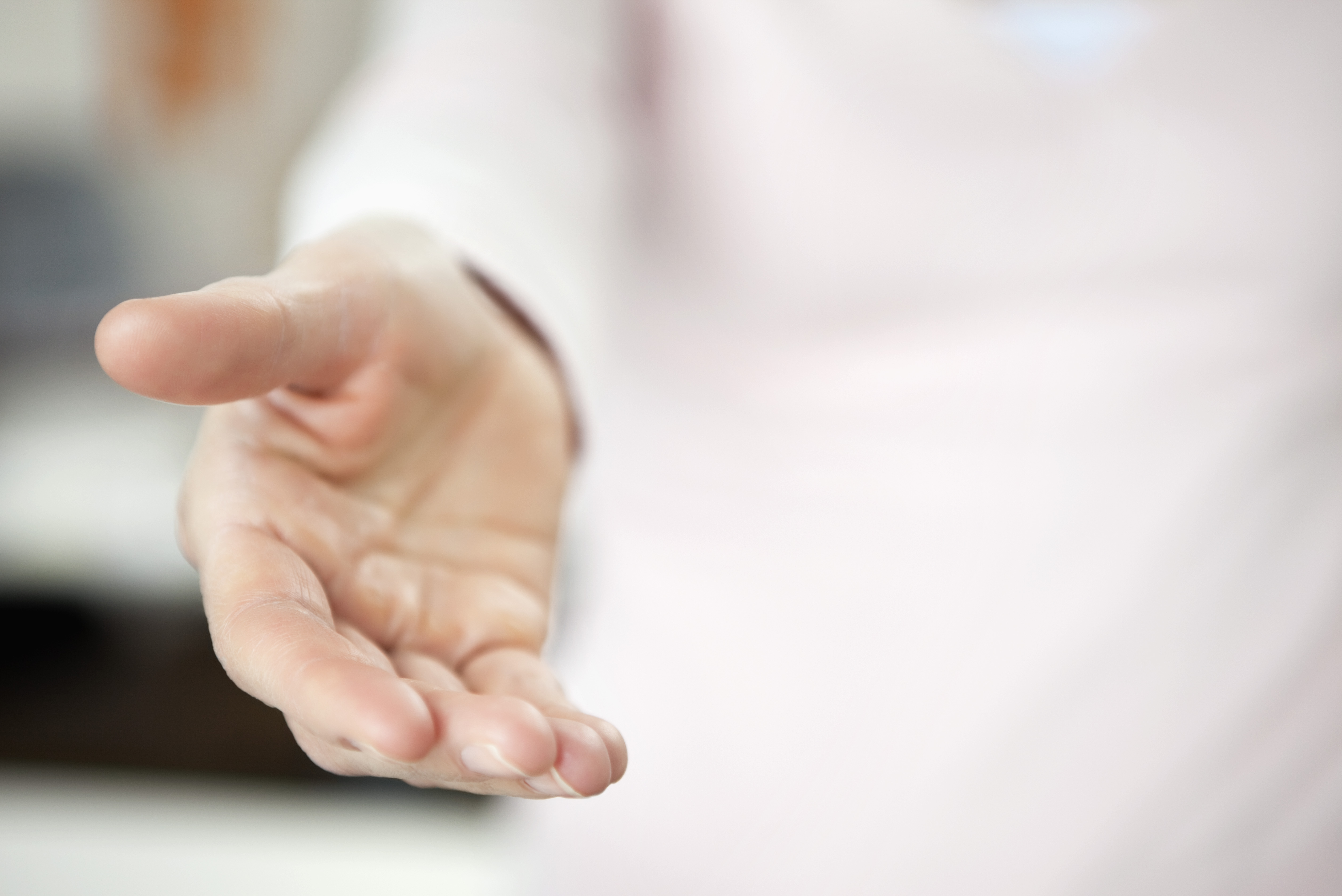 Close-up of a person holding out helping hand