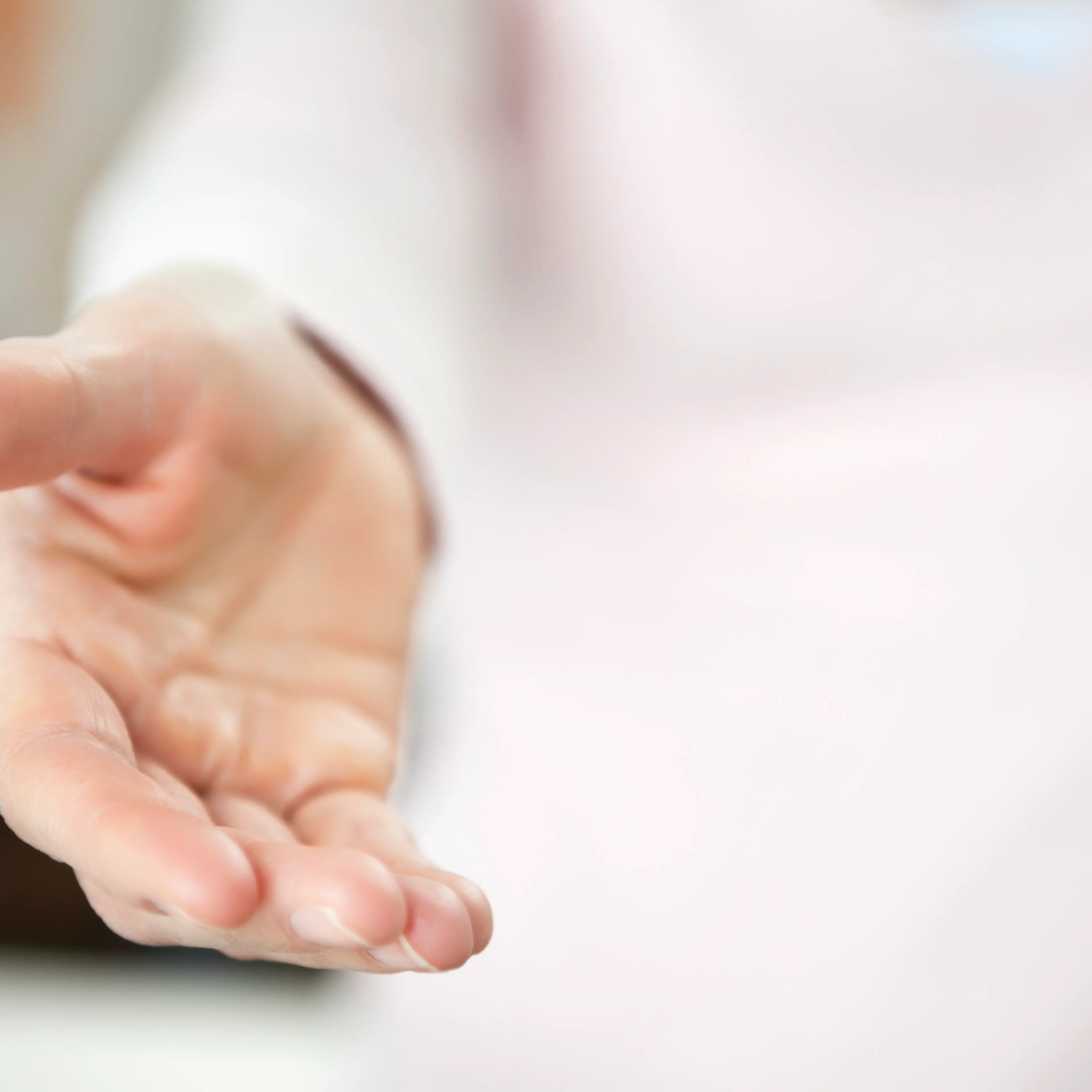 Close-up of a person holding out helping hand