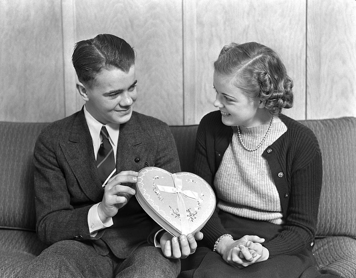 Smiling Teen Couple Sitting On A Sofa The Boy Dres