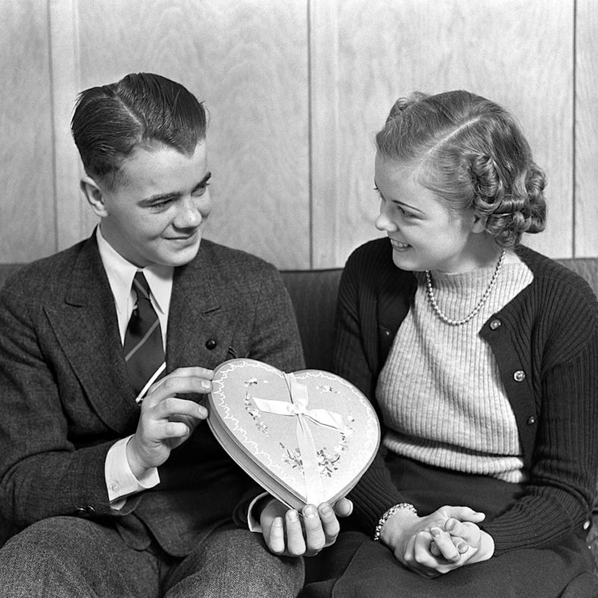 Smiling Teen Couple Sitting On A Sofa The Boy Dres