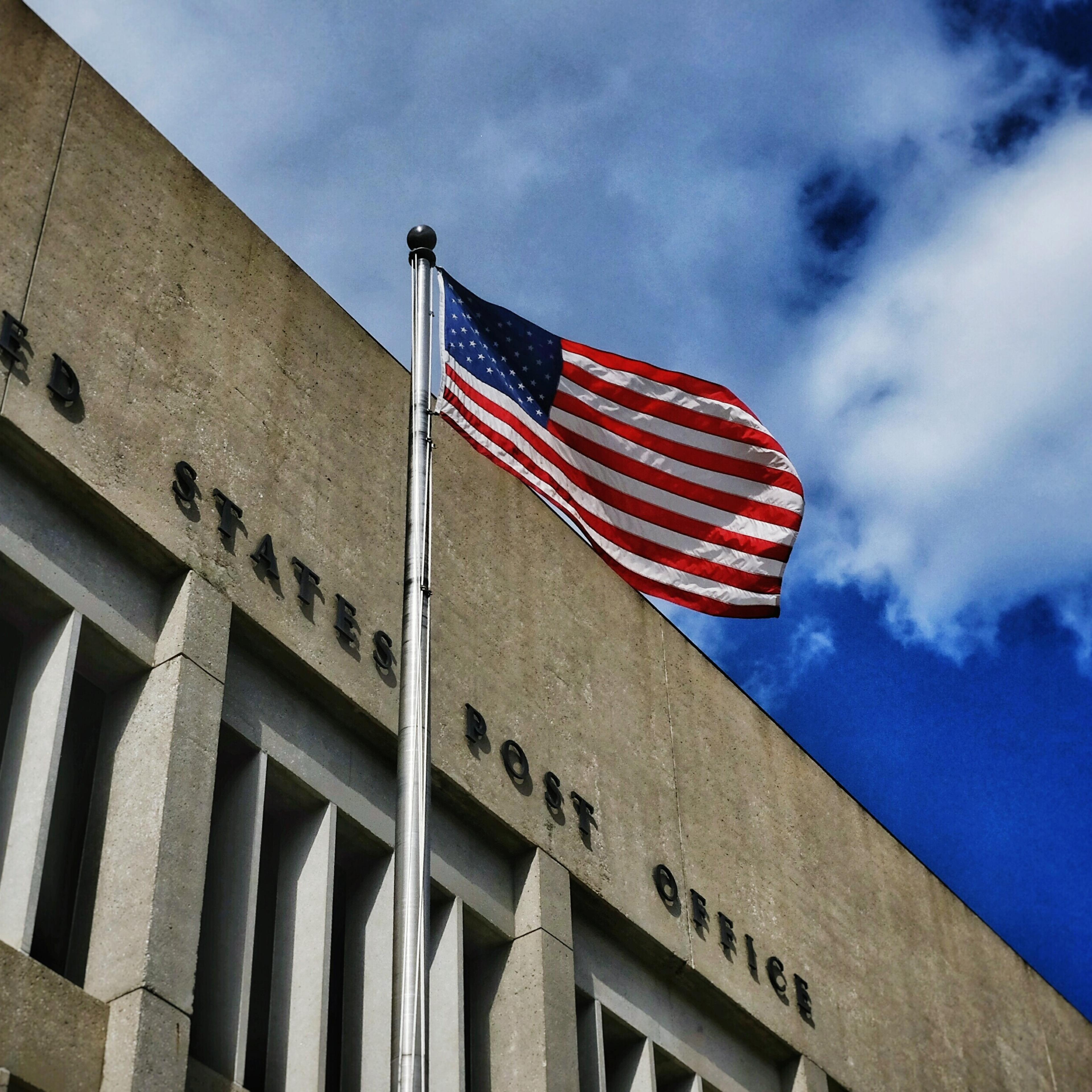Low Angle View Of Post Office Against Blue Sky