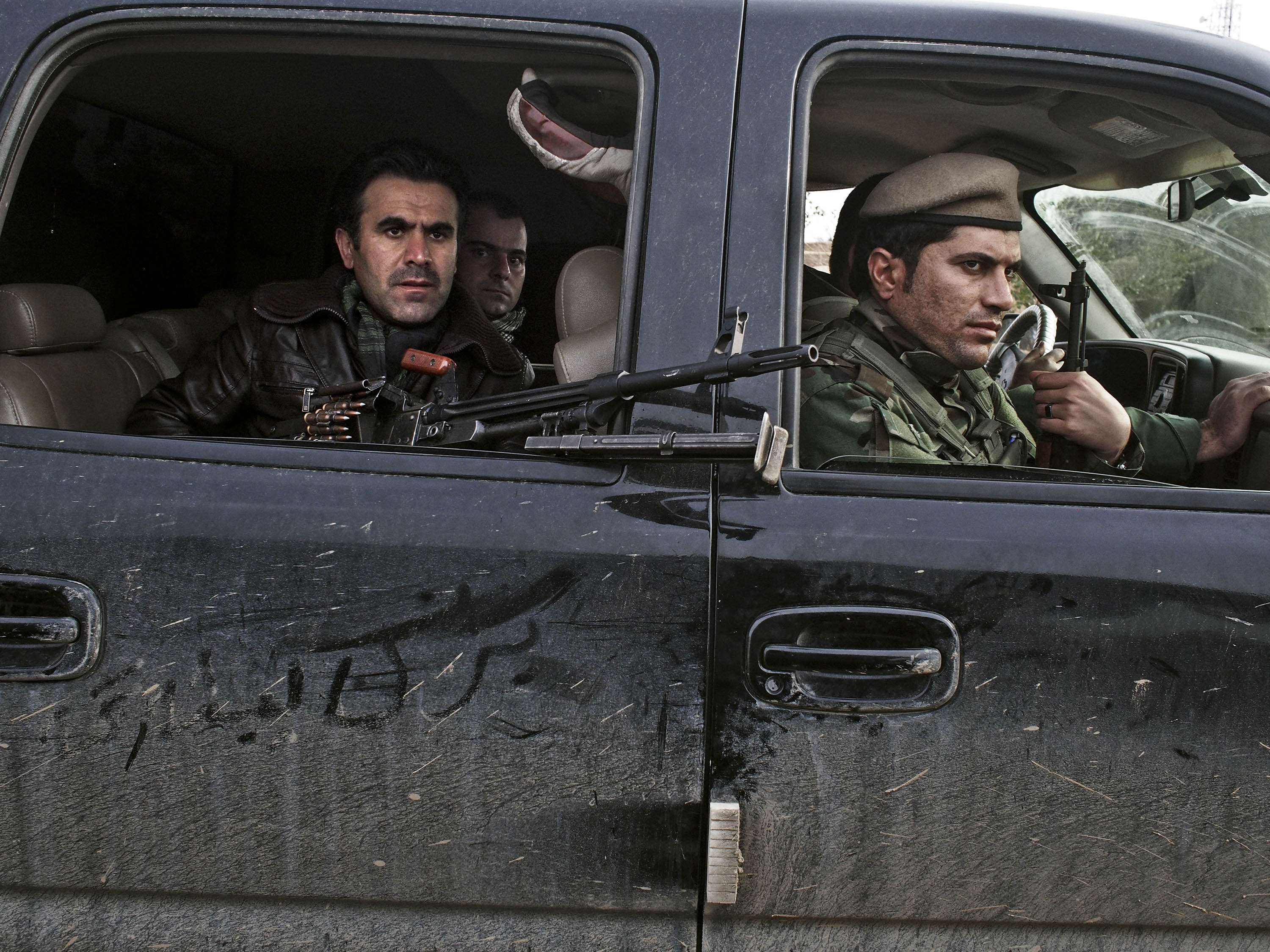 Counterattack: Kurdish soldiers drive through an Iraqi village in December after taking it back from ISIS forces