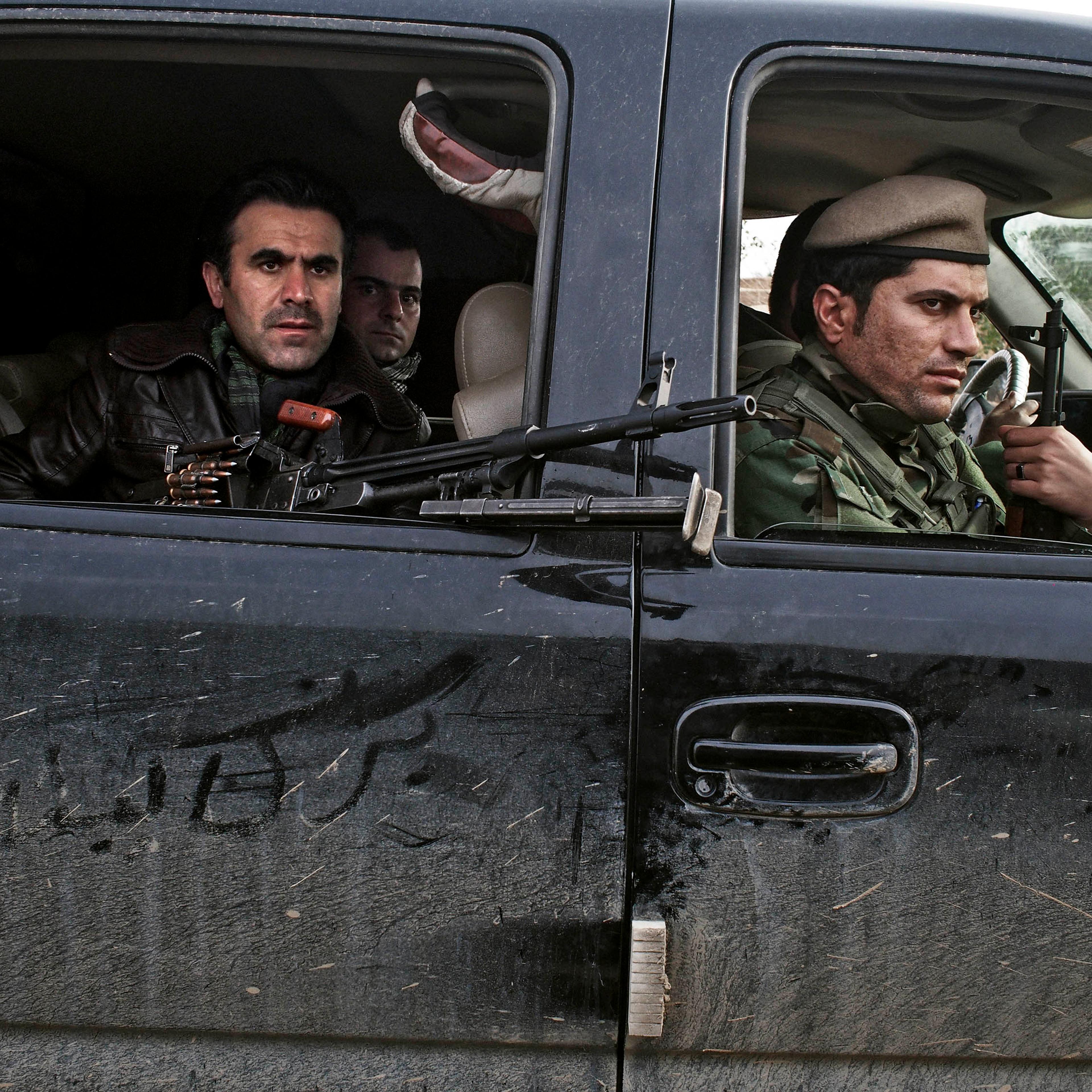 Counterattack: Kurdish soldiers drive through an Iraqi village in December after taking it back from ISIS forces