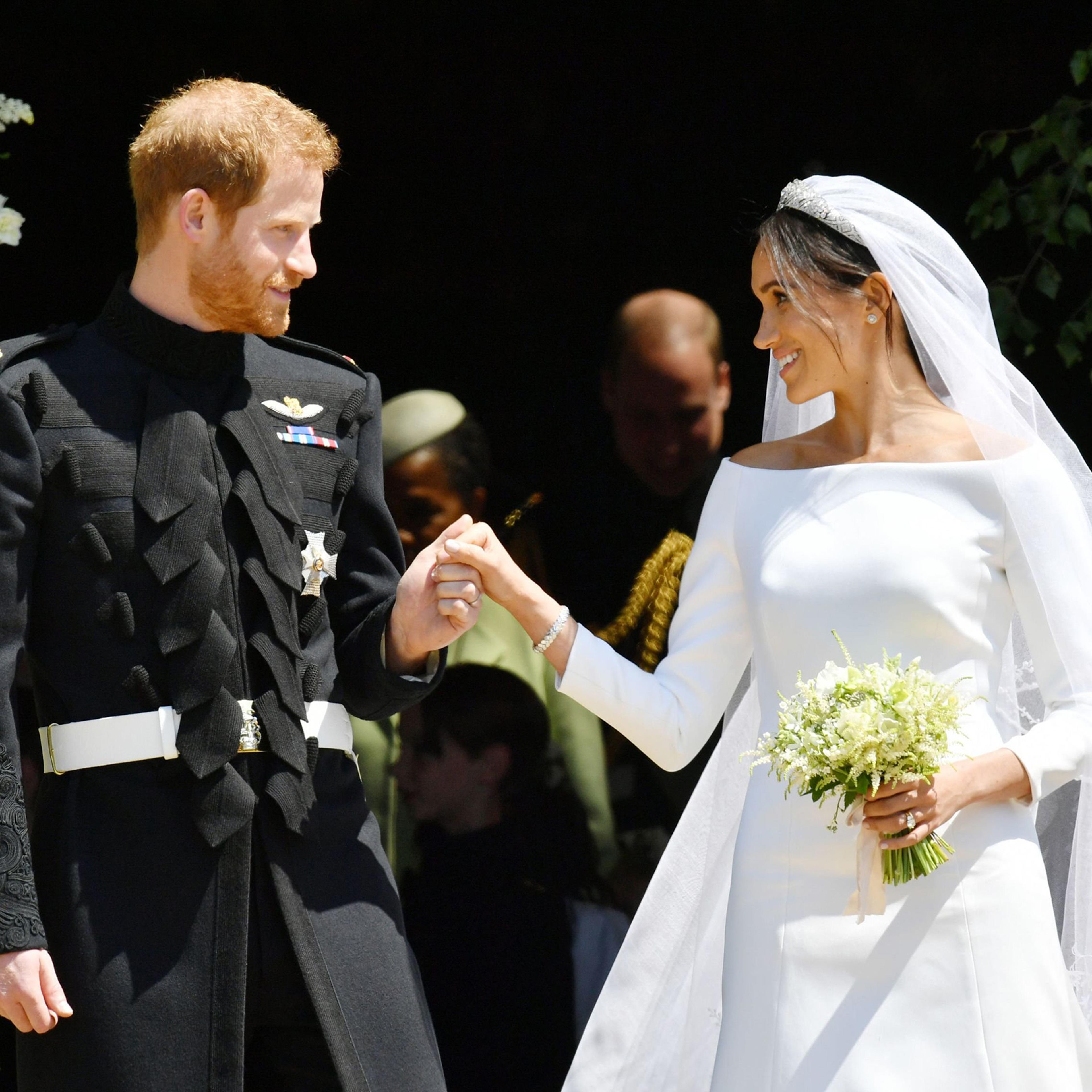 Prince Harry, Duke of Sussex and Meghan, Duchess of Sussex emerge from the West Door of St George's Chapel, Windsor Castle, in Windsor, on May 19, 2018.